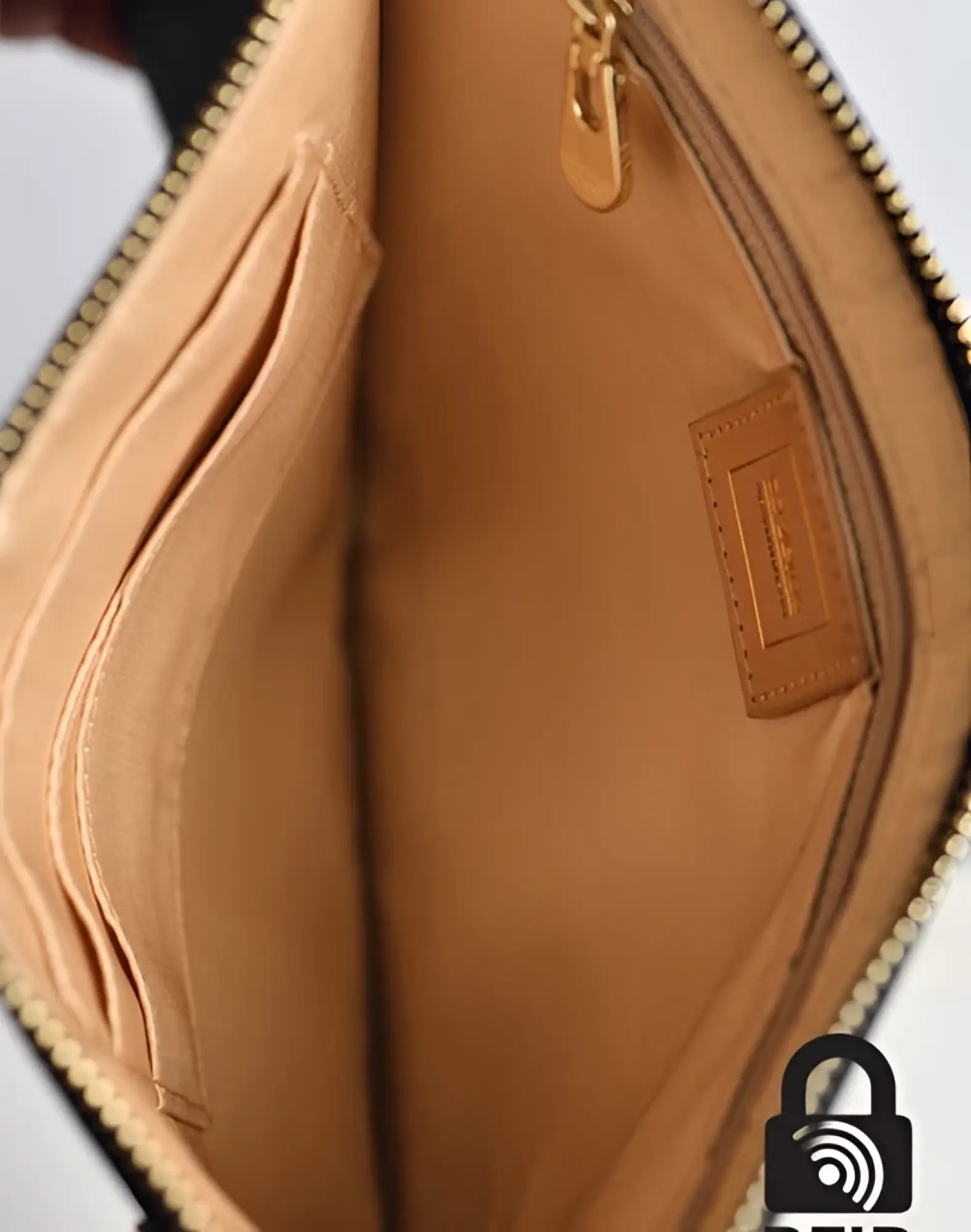 Tan leather 2EROS RFID icon carry all clutch with gold-tone zipper and stitched interior brand tag