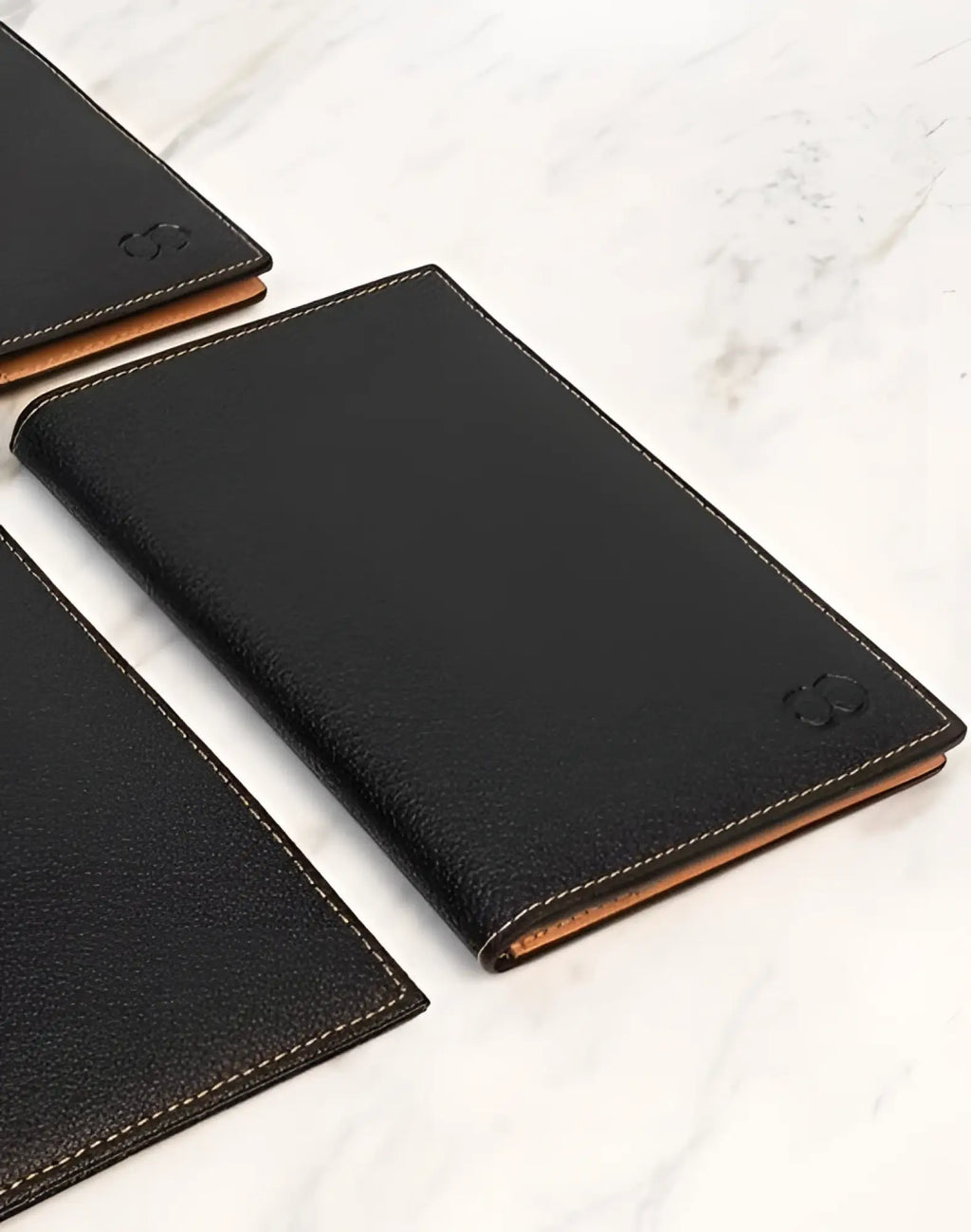 Black leather 2EROS RFID icon passport wallet with tan stitching and subtle embossed logo for secure travel