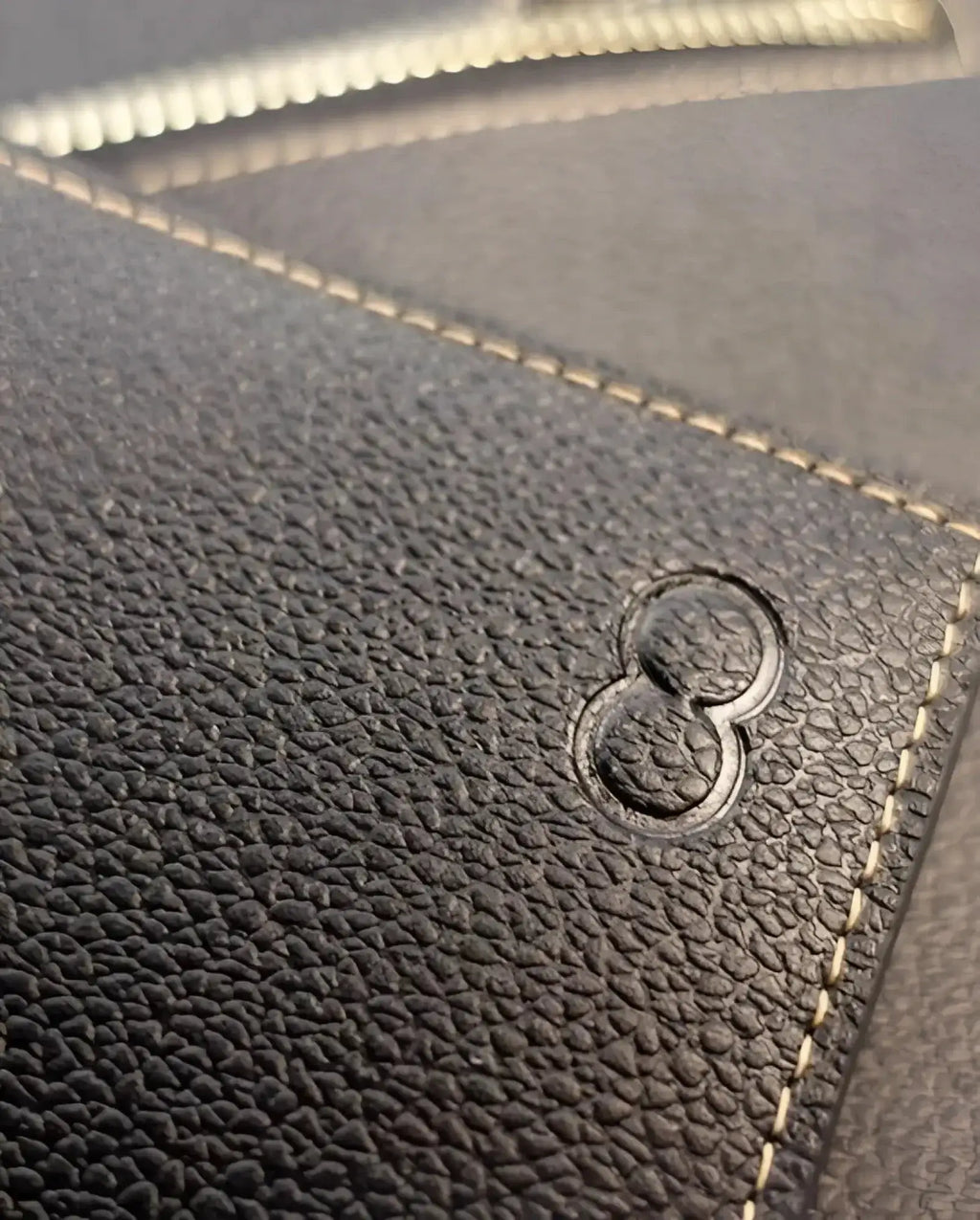 Dark textured leather 2eros rfid icon wallet with embossed number eight logo and contrasting light stitching