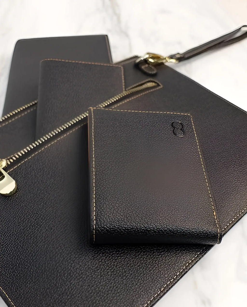 Dark brown leather 2eros rfid icon wallet with textured surface and gold toned zipper pull