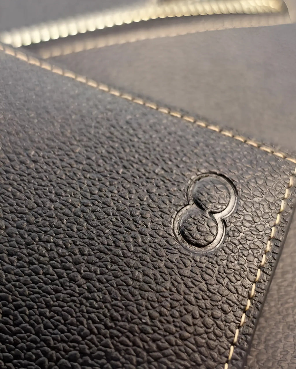 Dark textured leather 2eros rfid icon wallet with embossed number eight logo and contrasting light stitching