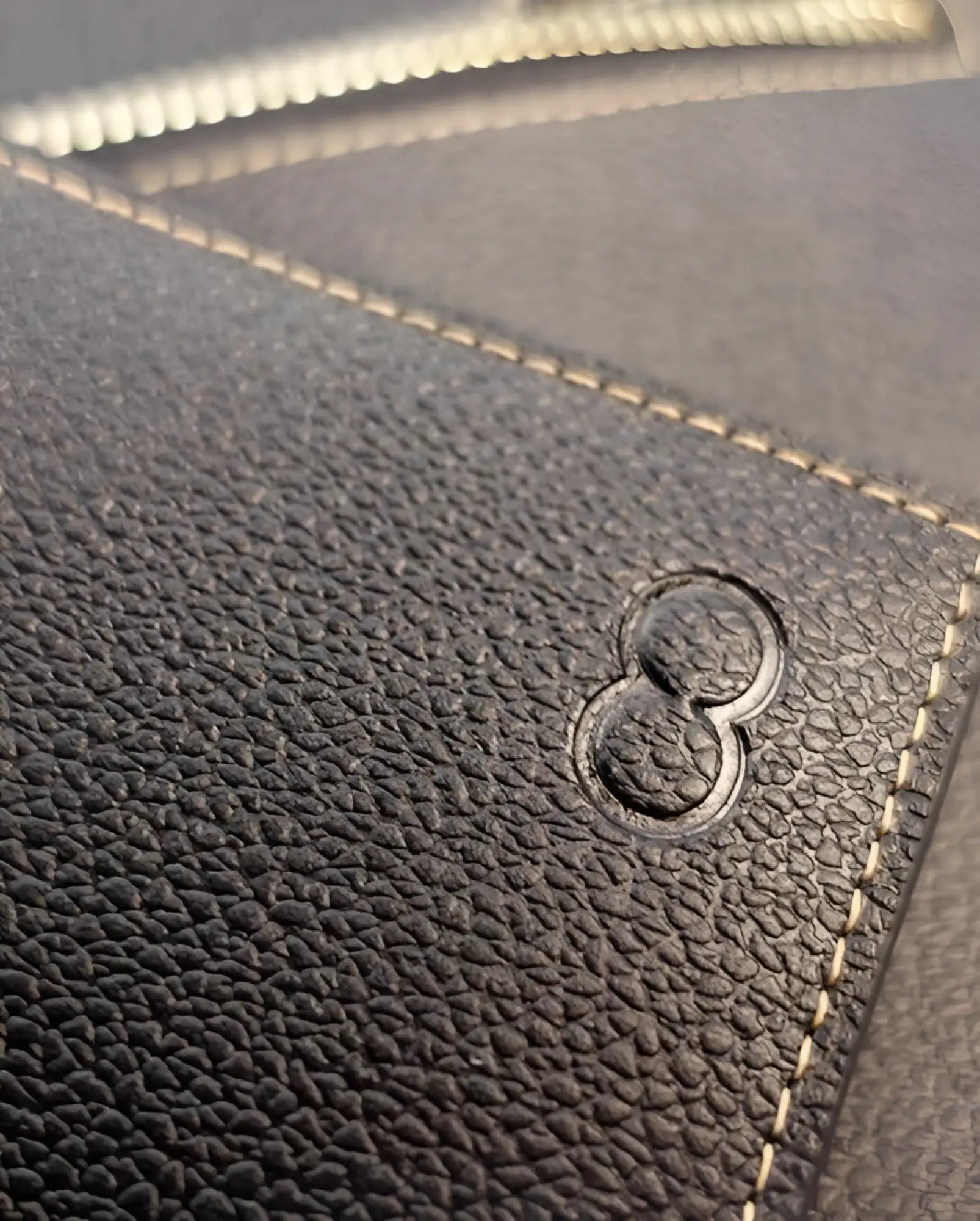 Dark textured leather 2eros rfid icon wallet with embossed number eight logo and contrasting light stitching