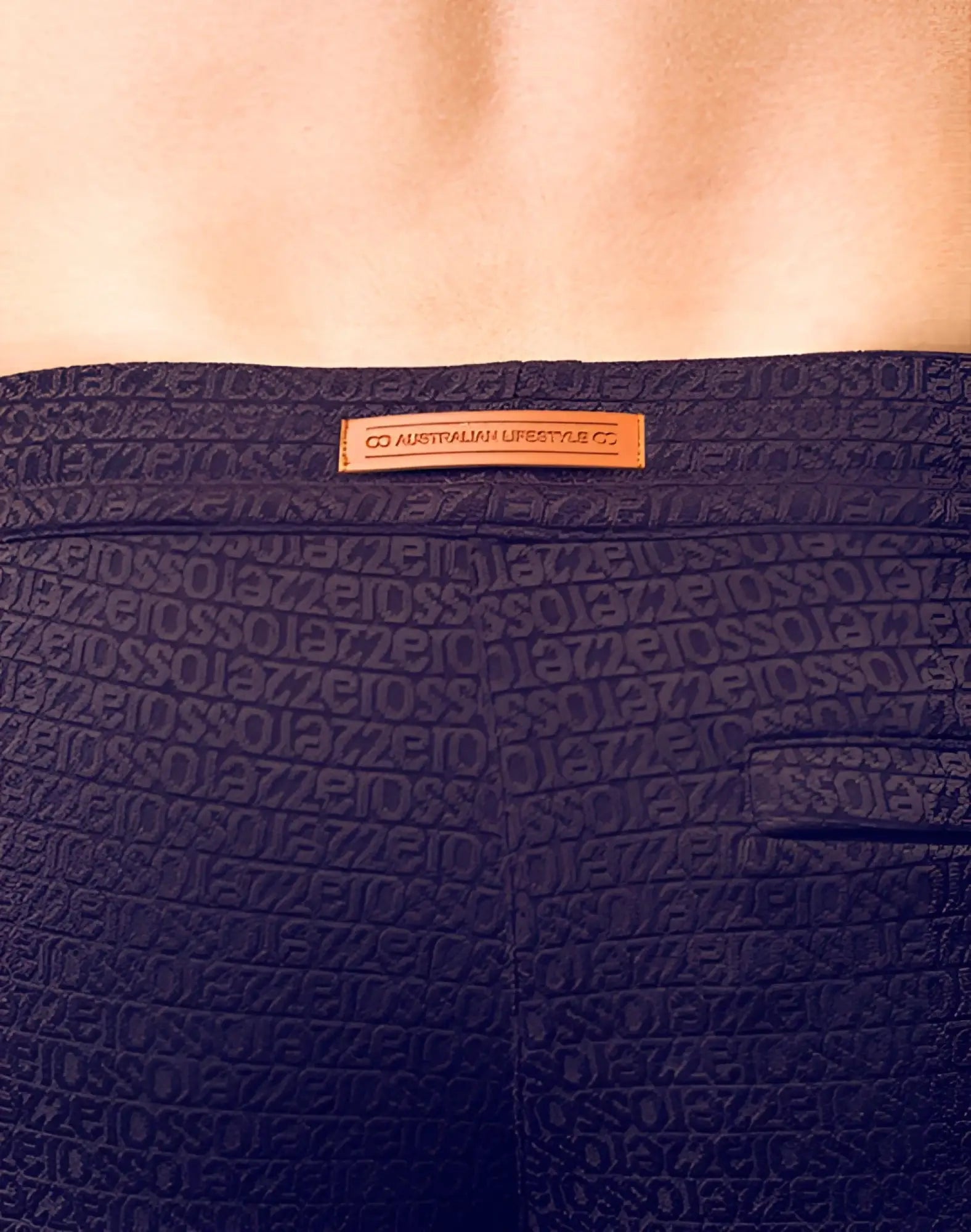 Dark navy blue textured 2eros s90 manly shorts with repeating geometric pattern and orange leather brand tag