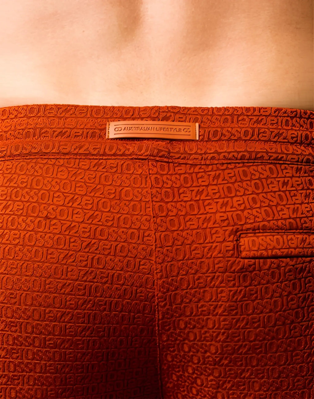 Orange 2EROS S90 textured manly shorts with embossed letters and numbers pattern and a small leather brand tag