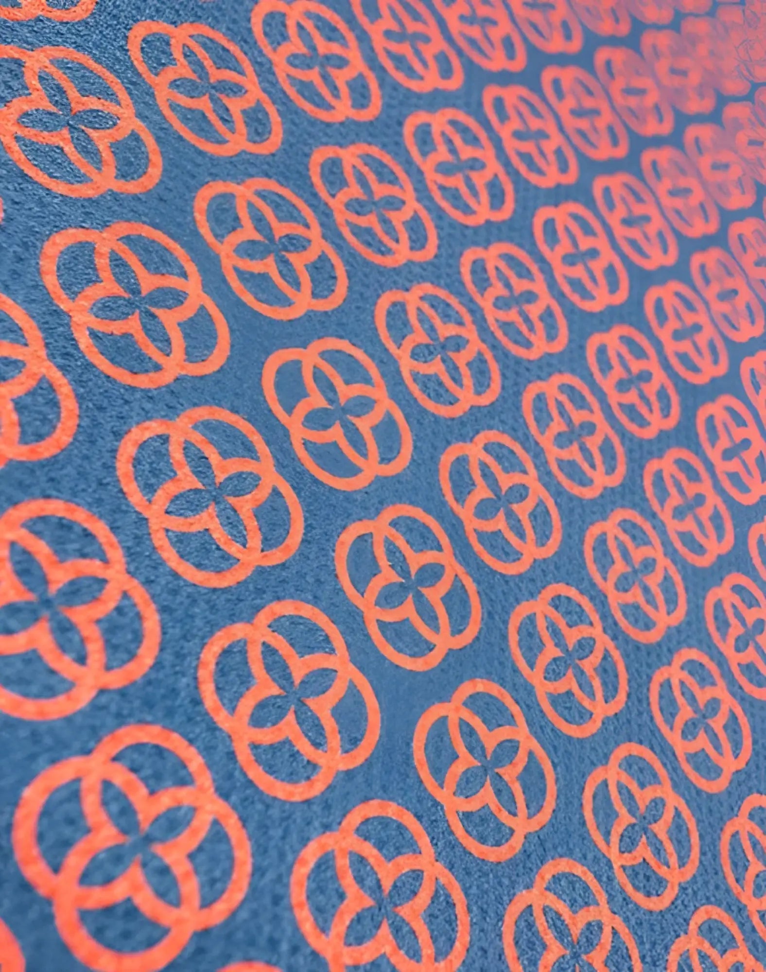 Blue 2eros sand free beach towel with repeating orange quatrefoil pattern perfect for sand free use