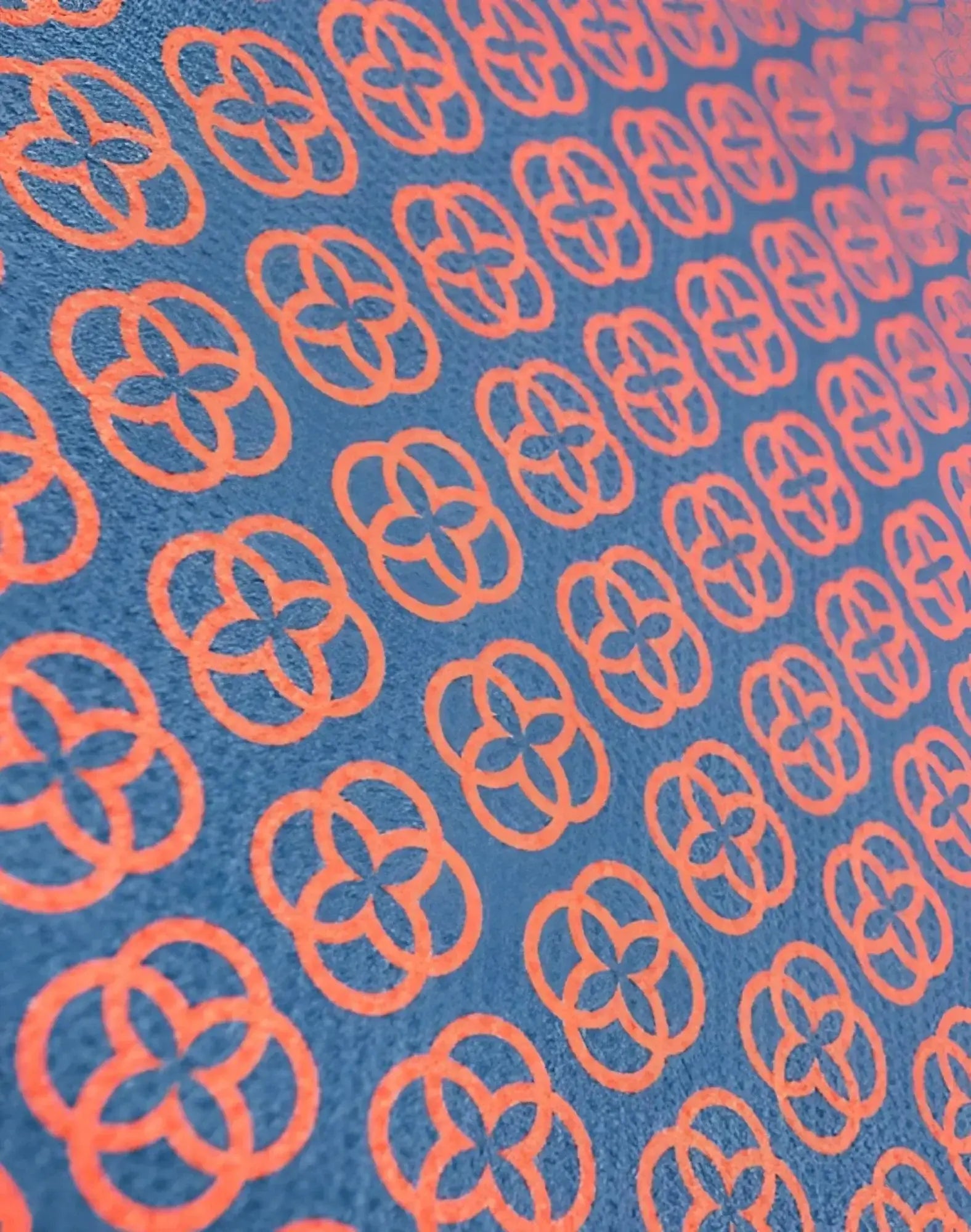 Blue 2eros sand free beach towel with repeating orange quatrefoil pattern perfect for sand free use