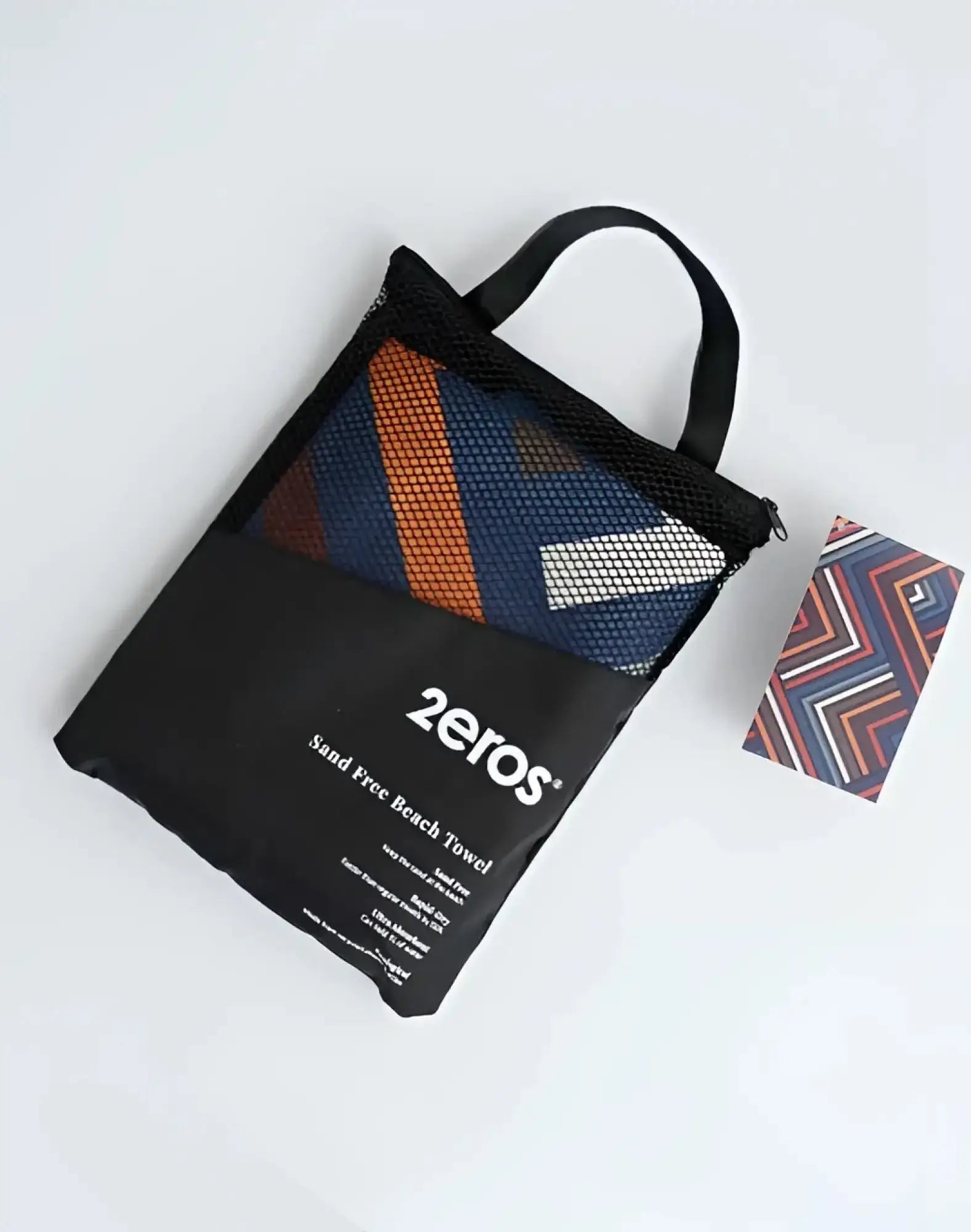 2eros sand free beach towel avant morocco in navy blue with orange and white stripes in black mesh carry bag