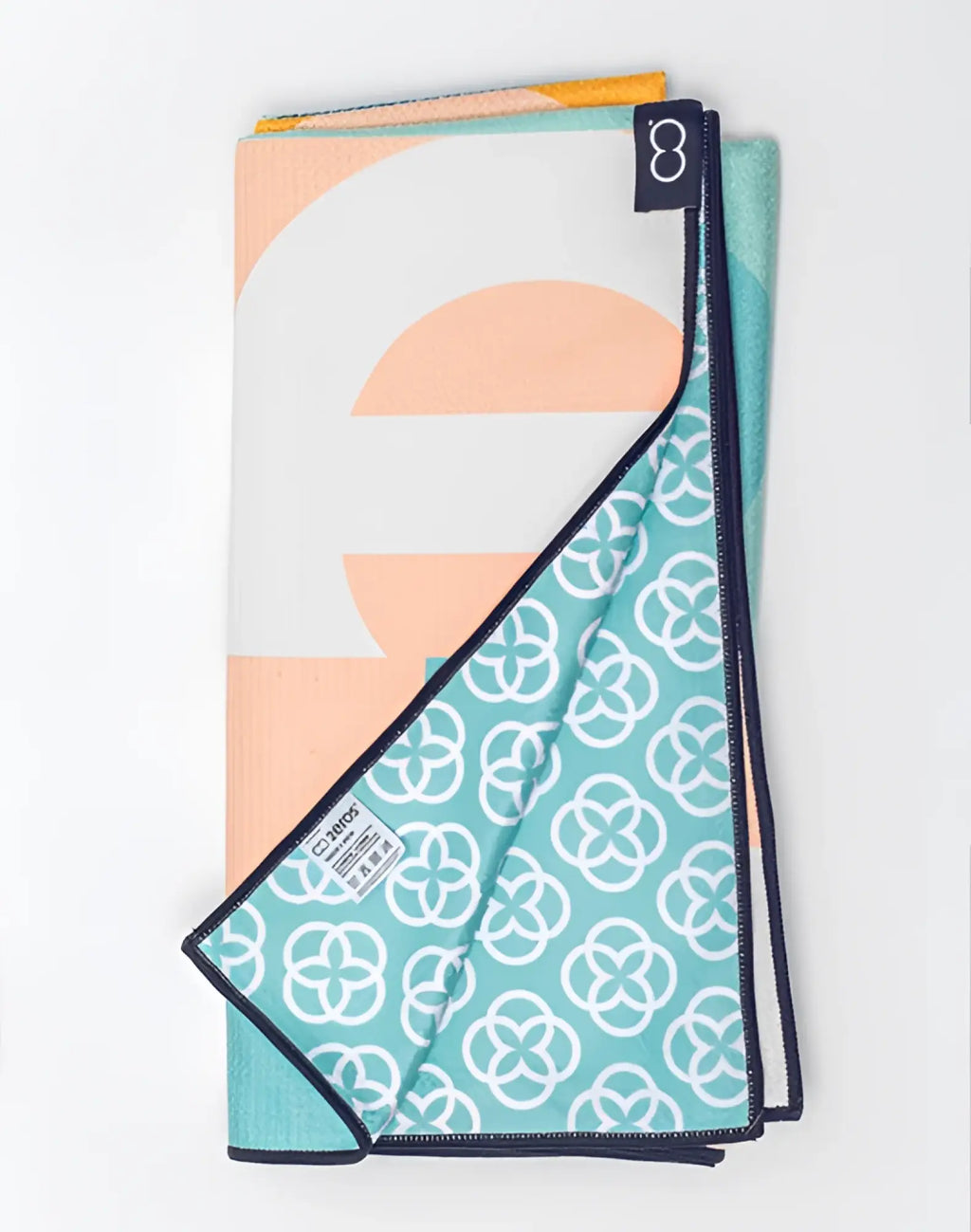 Folded 2eros sand-free beach towel insignia turquoise with soft peach white teal geometric and abstract patterns