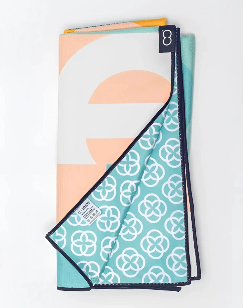 Folded 2eros sand-free beach towel insignia turquoise with soft peach white teal geometric and abstract patterns