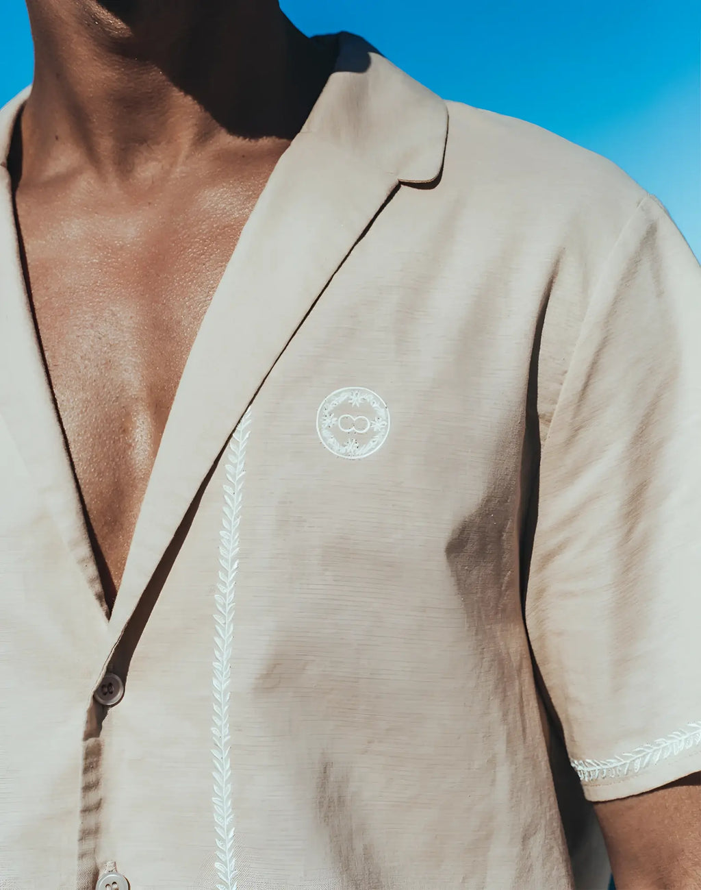 Beige linen short-sleeved 2EROS Santorini Shirt with white embroidered details and circular chest logo in taupe