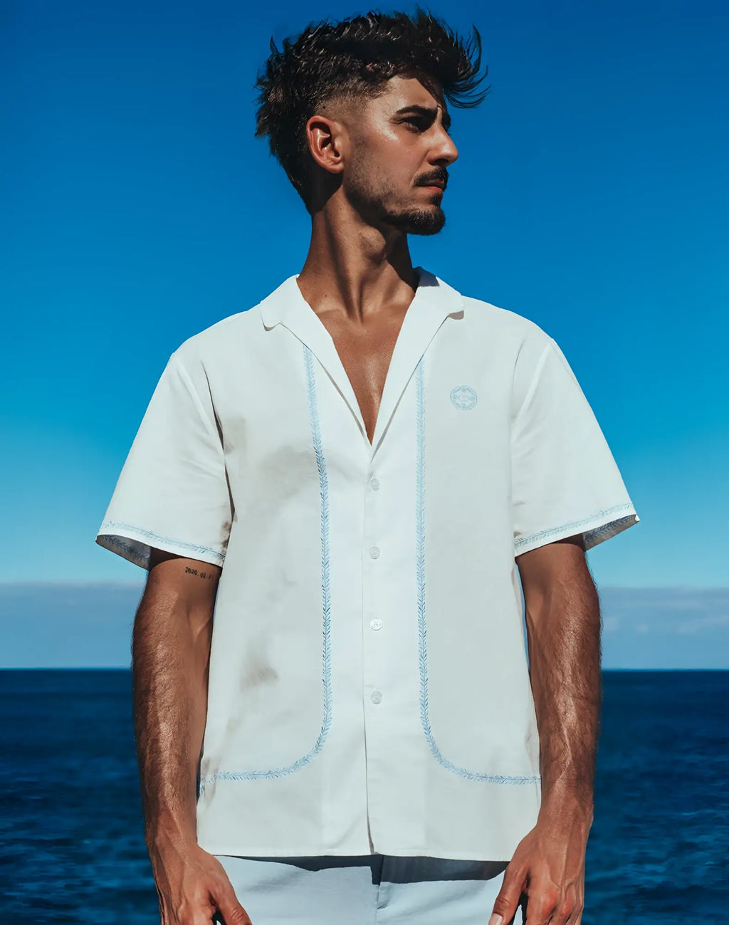 White short-sleeved button-up shirt with light blue embroidered trim on placket and pockets by 2EROS Santorini