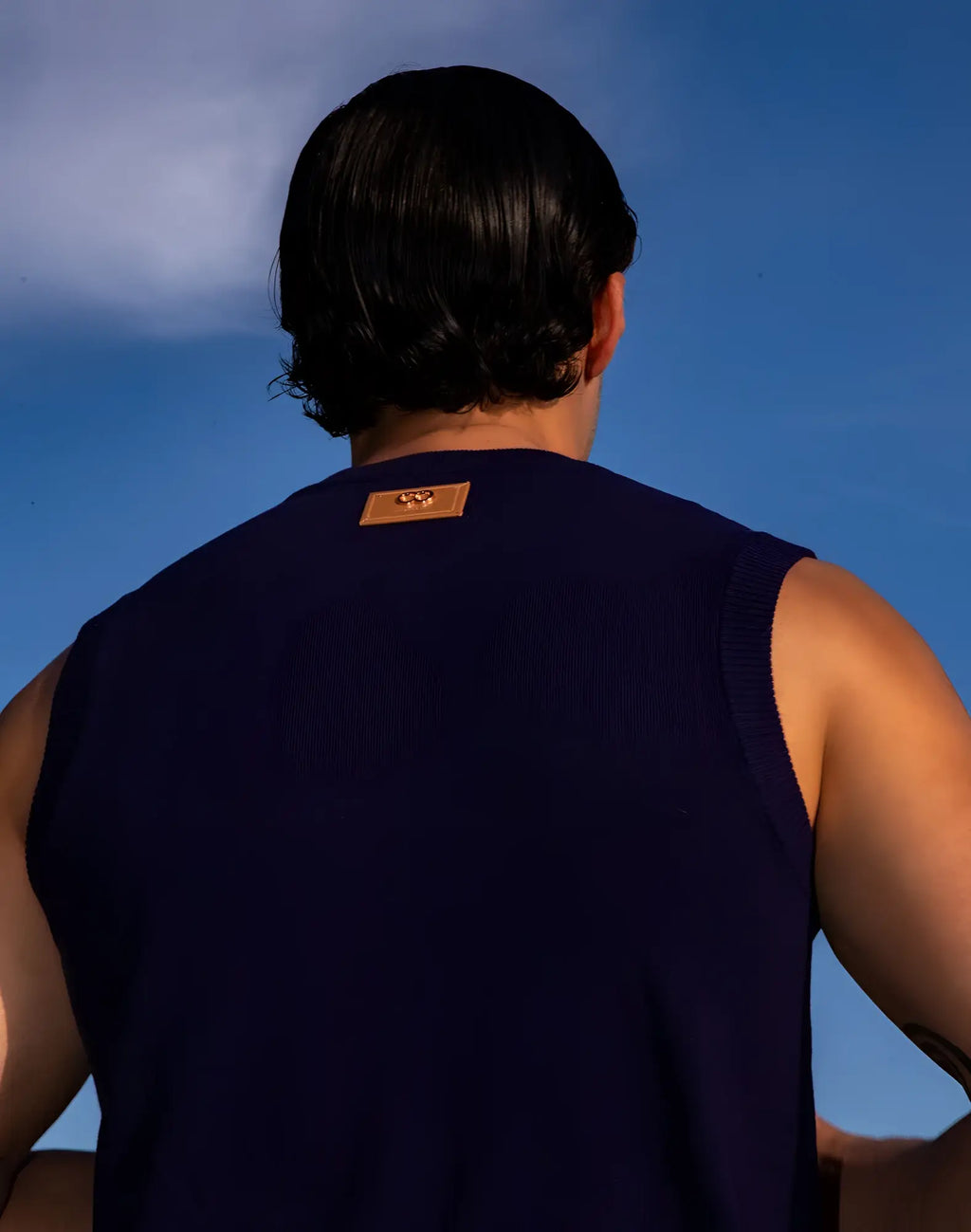 2eros sapphire knit vest navy featuring a dark navy sleeveless knit top with a tan leather patch at the neckline