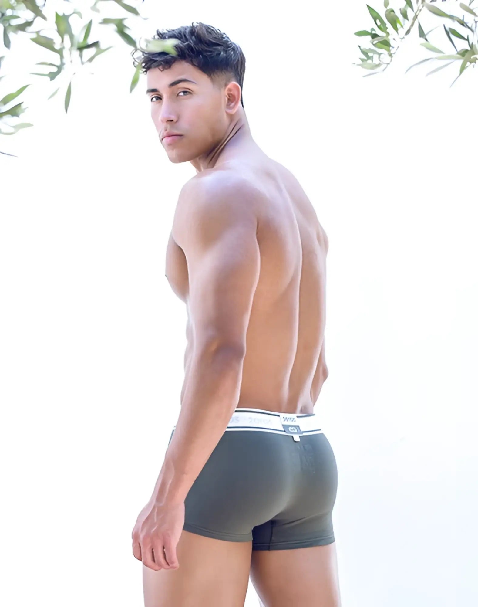 Dark gray calvin klein boxer briefs with white elastic waistband and logo paired with 2EROS titan trunk underwear deep depths green