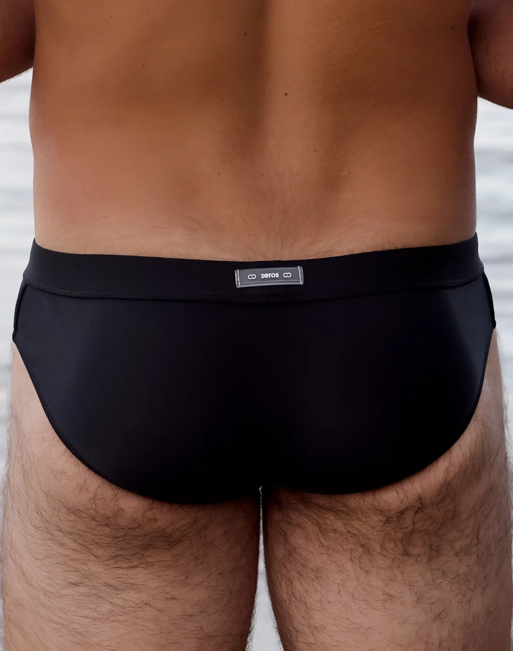 Black 2EROS V10 AKTIV racer swim briefs with sleek form-fitting design and subtle brand tag at the waistband