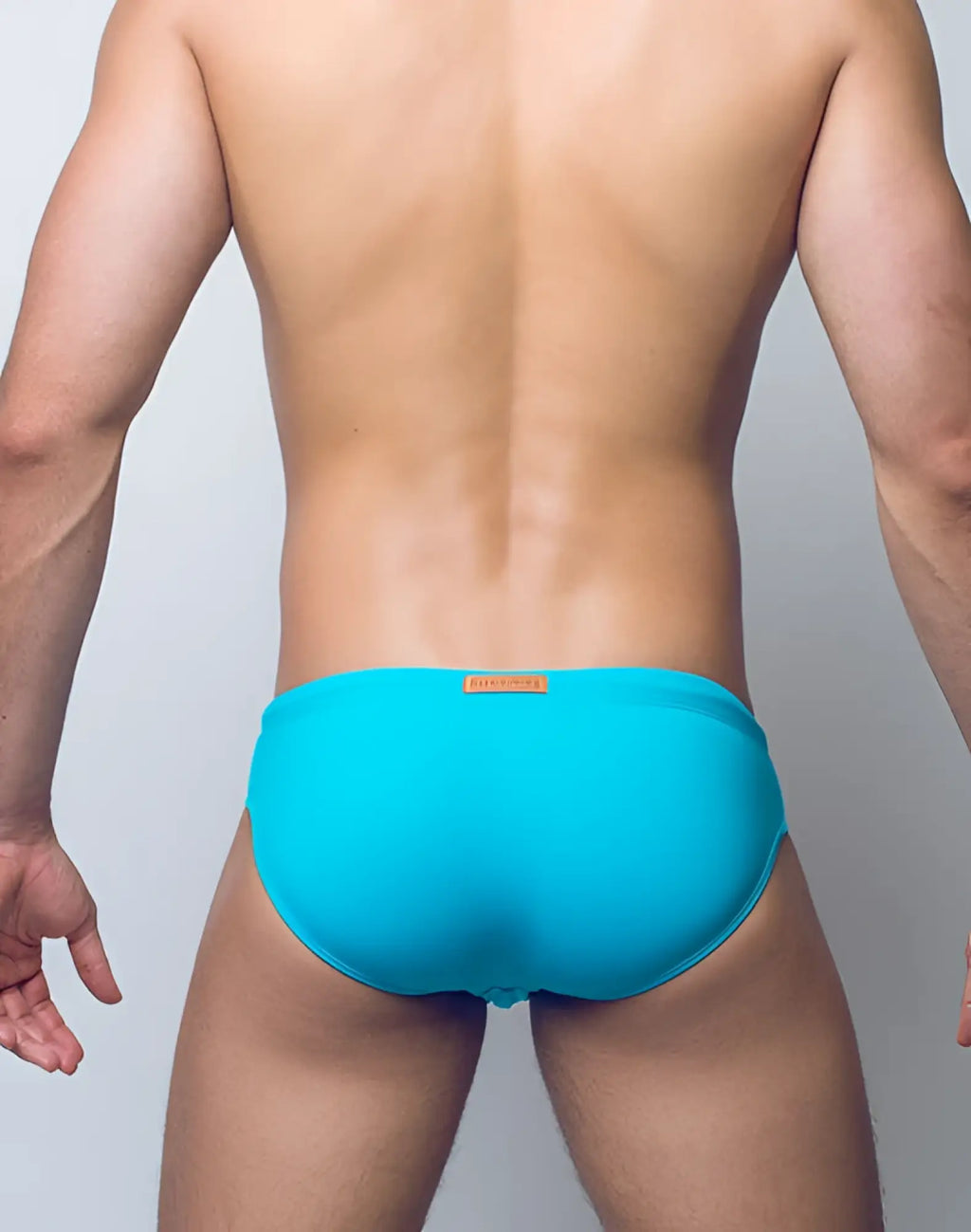 Bright turquoise 2EROS V10 Core Series 2 swim trunks with orange brand tag at waistband for swimwear in aqua color