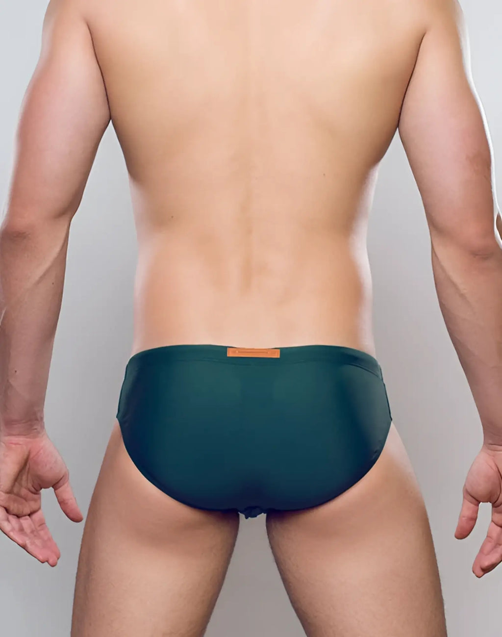 Dark green 2EROS V10 Core Series 2 swim trunks with subtle sheen and orange rectangular brand tag at waistband