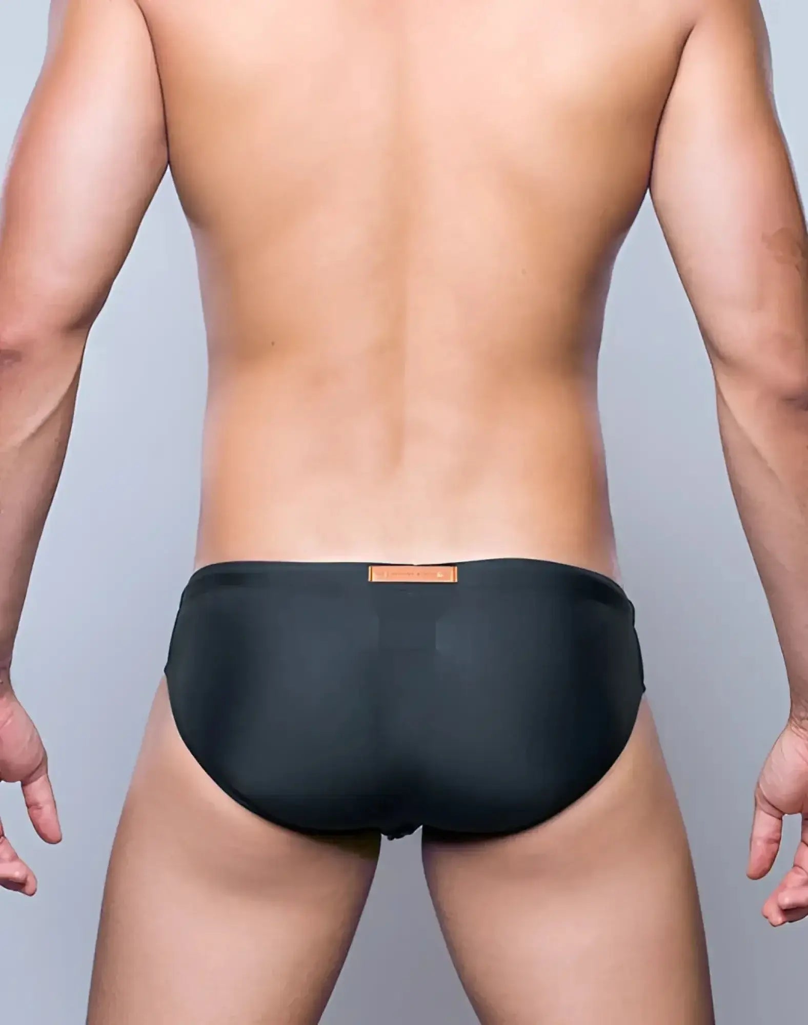 2EROS V10 Core Series 2 swimwear in midnight grey featuring black swim trunks with a subtle orange waistband label