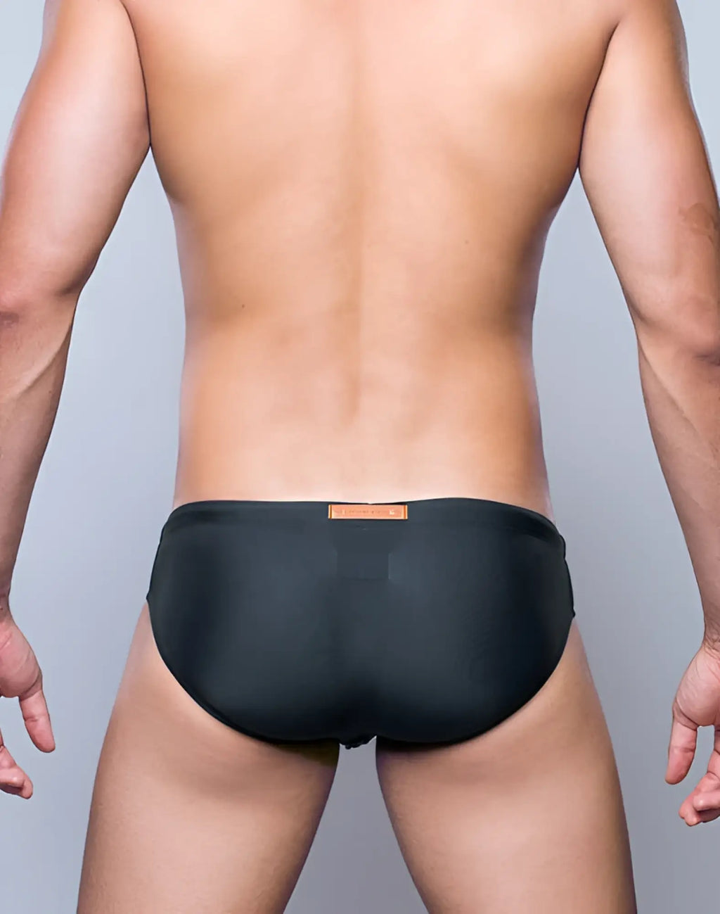 2EROS V10 Core Series 2 swimwear in midnight grey featuring black swim trunks with a subtle orange waistband label