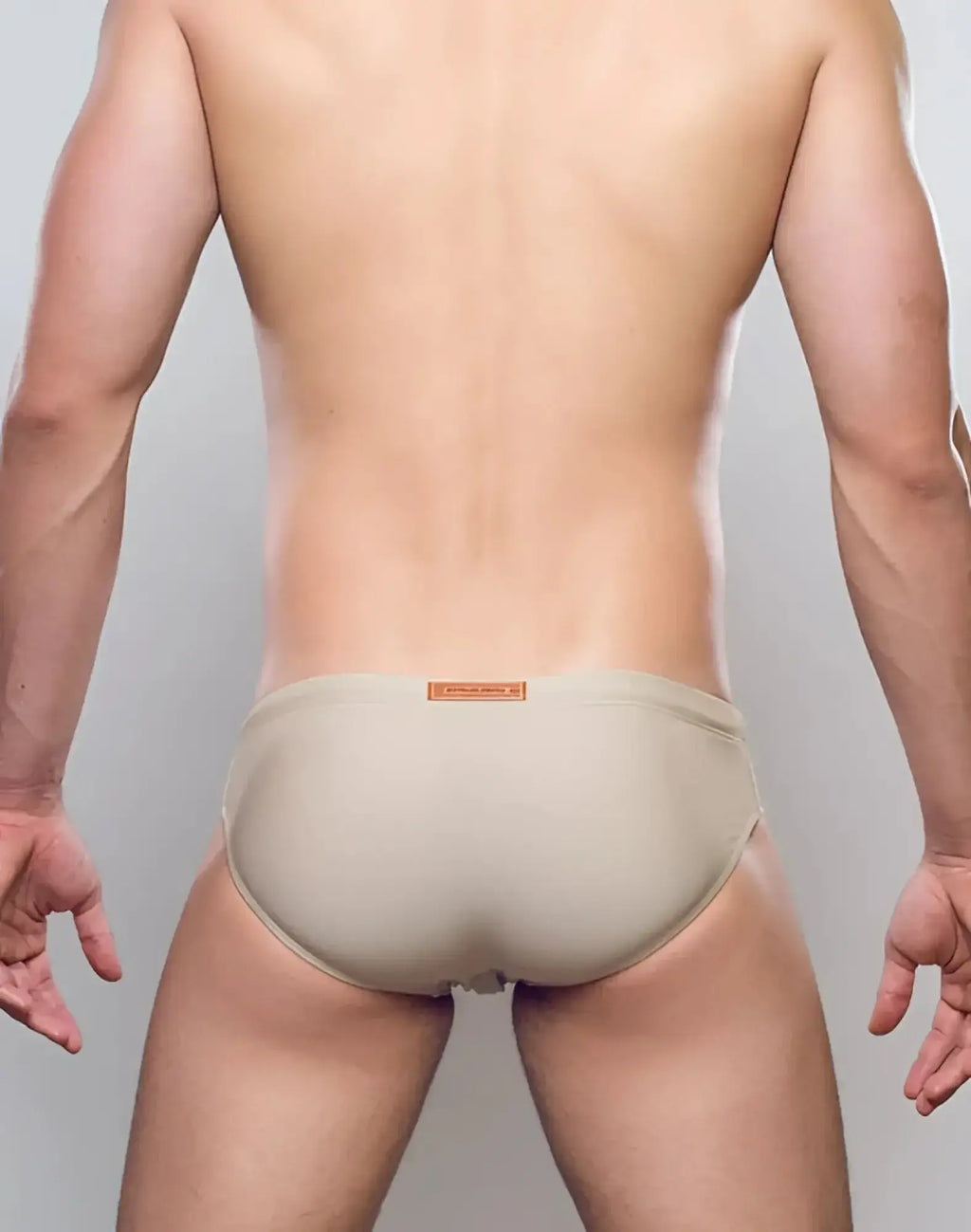 Beige seamless 2EROS V10 Core Series 2 swimwear briefs with small orange label on waistband in taupe color