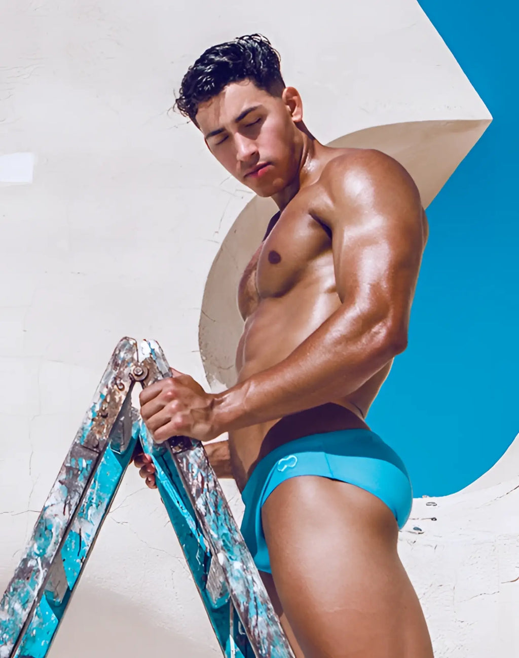 Bright turquoise 2eros v10 core swim trunks with black waistband and subtle heart logo for pacific coast use
