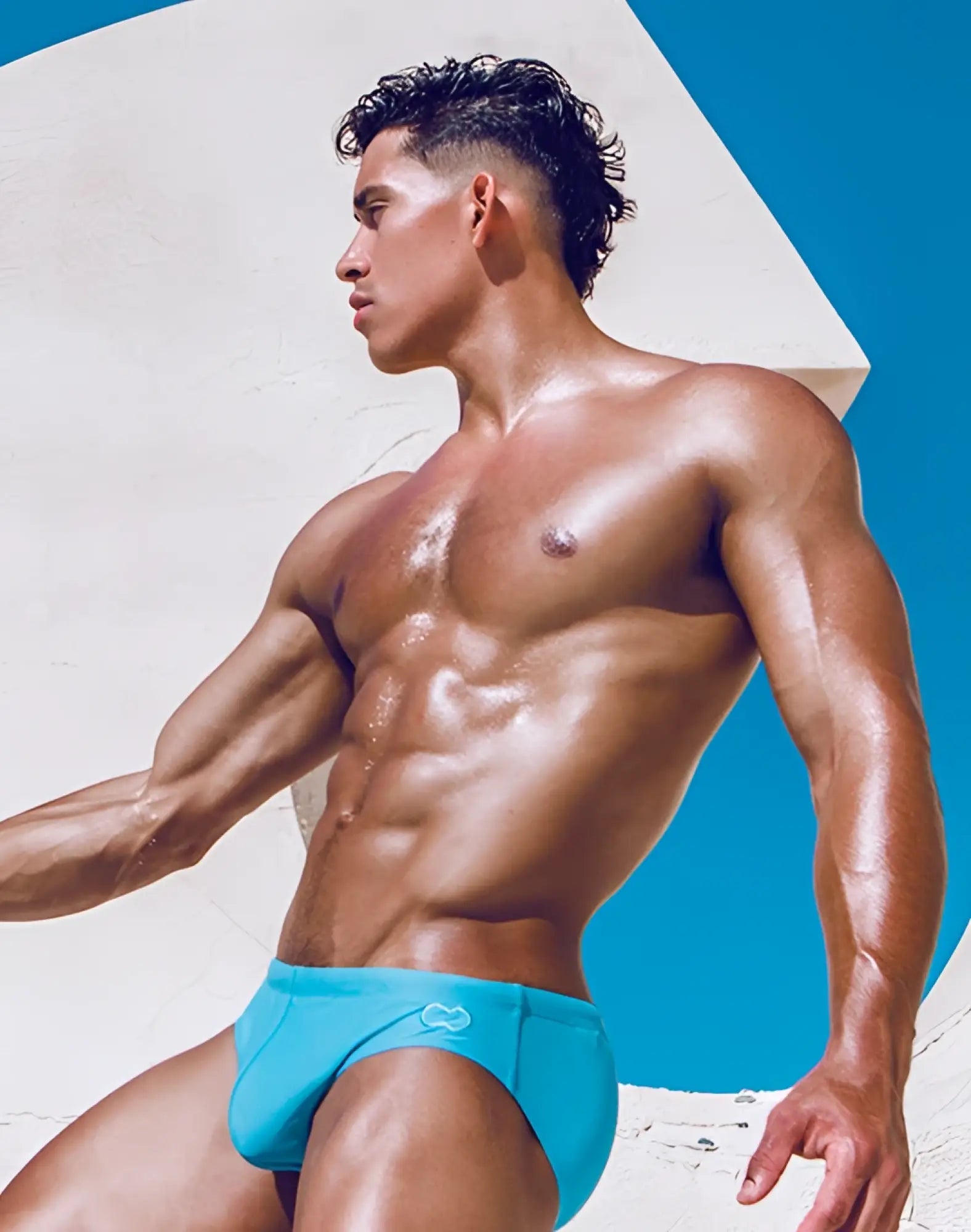 Bright turquoise 2EROS V10 Core swim trunks with subtle logo designed for comfortable beach and pool wear