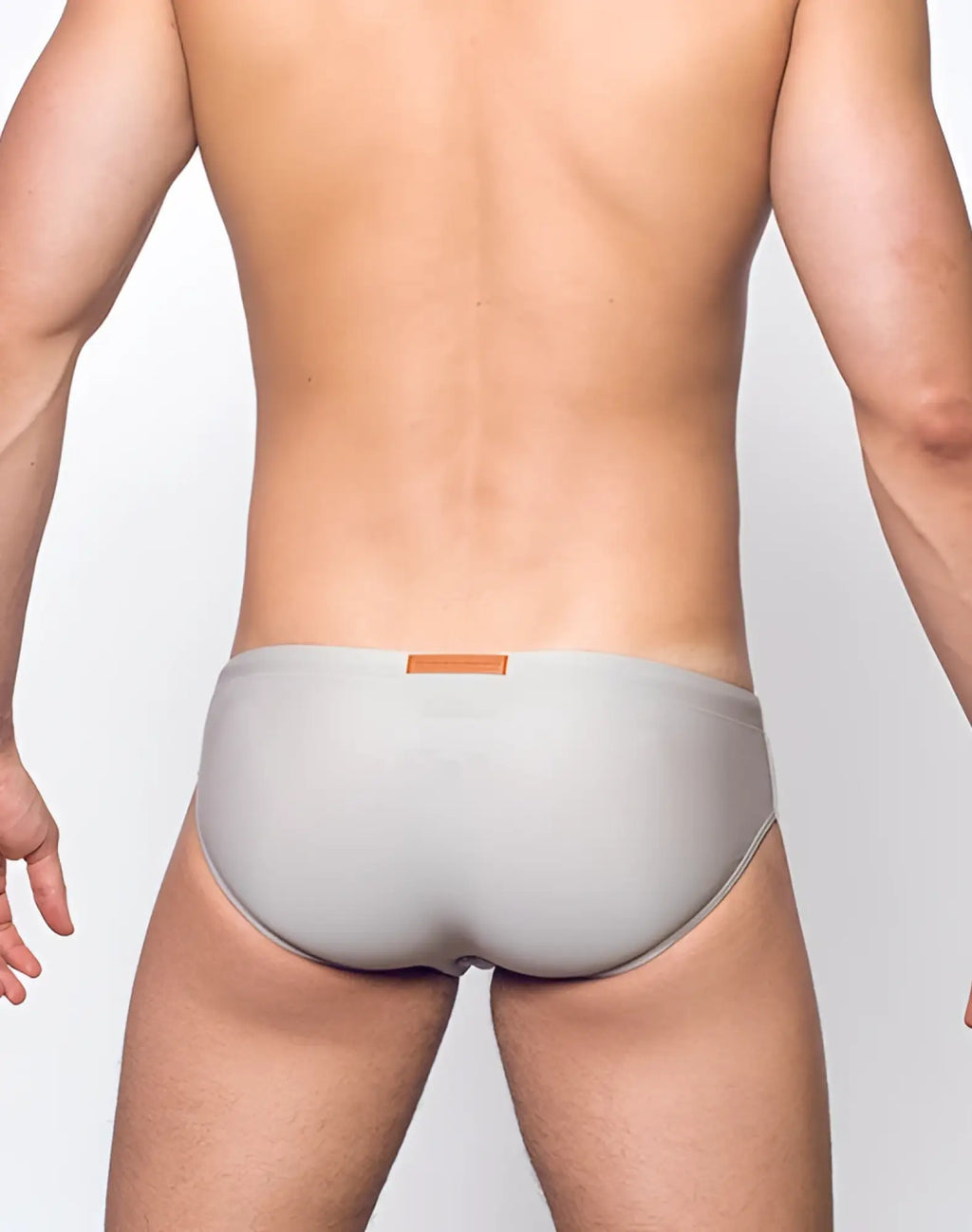 Gray 2EROS V10 Core Swimwear men’s briefs with orange rectangular waistband tag designed for swim use