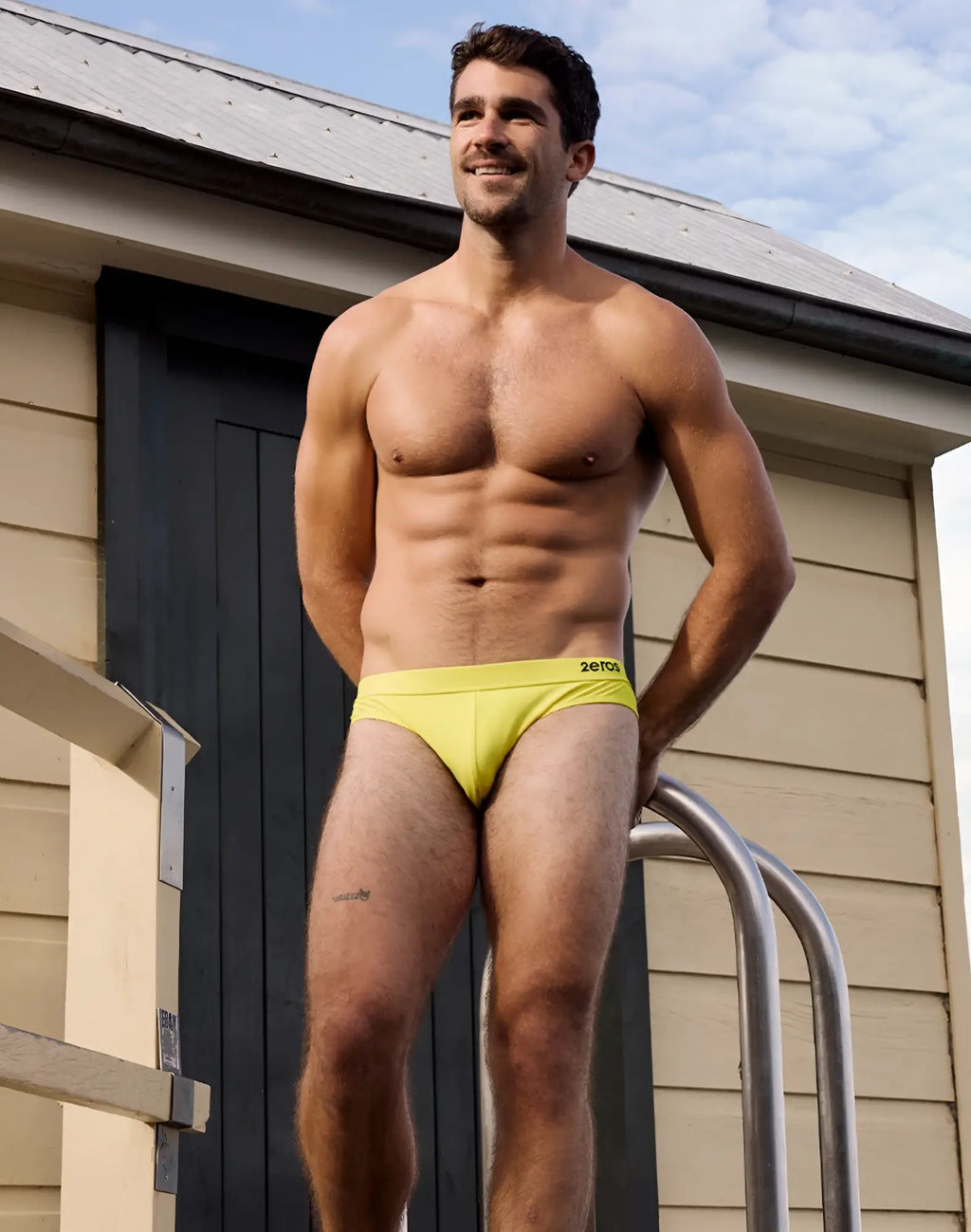 Bright yellow 2EROS V10 Encore men’s swim briefs with subtle black logo on waistband for swimming and beachwear