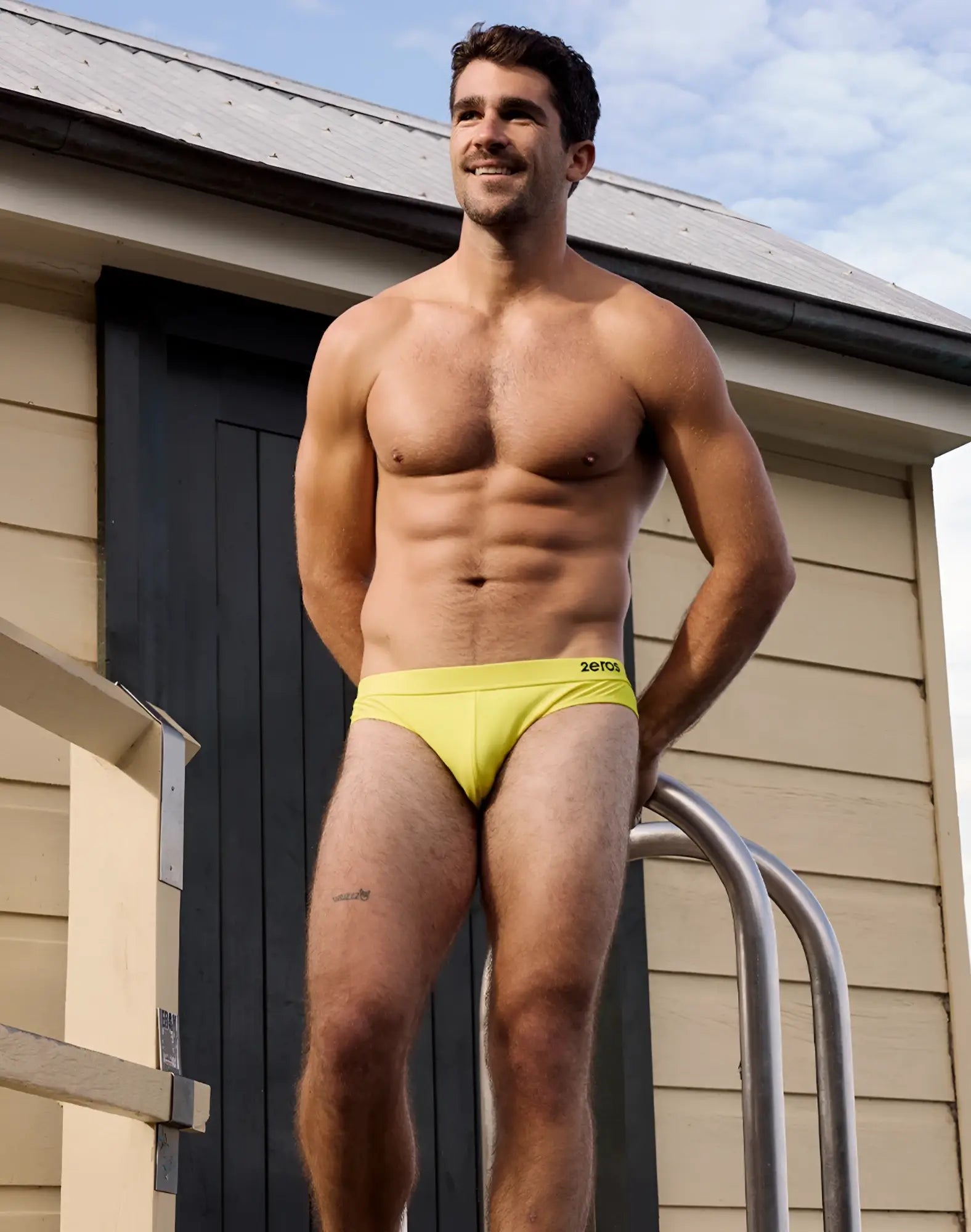 Bright yellow 2EROS V10 Encore men’s swim briefs with subtle black logo on waistband for swimming and beachwear