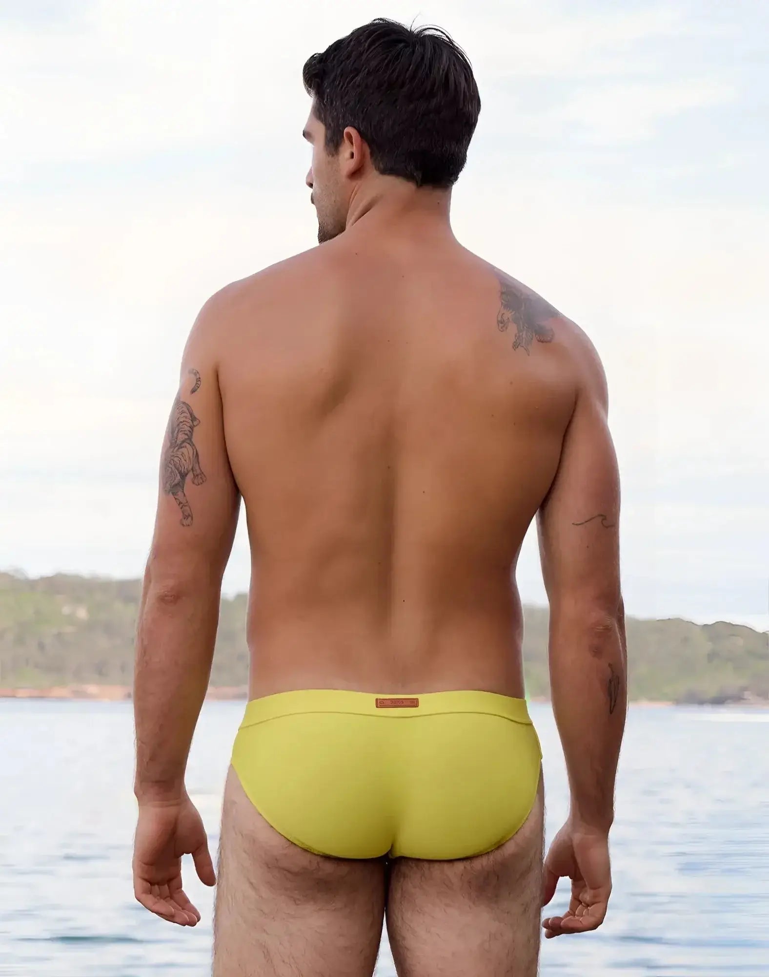 Bright yellow 2eros v10 encore swim brief with subtle brown brand tag at waistband for swimwear use