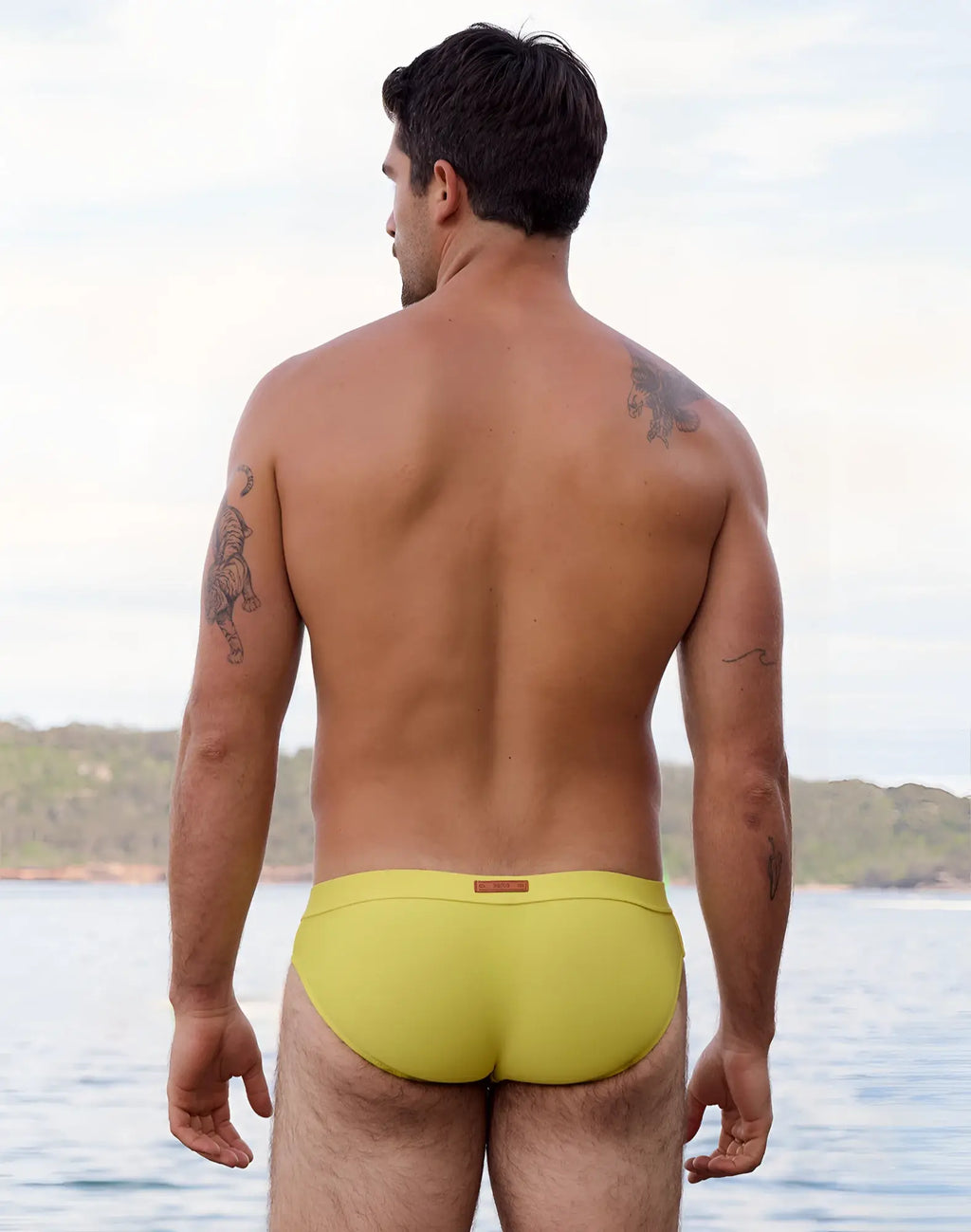 Bright yellow 2eros v10 encore swim brief with subtle brown brand tag at waistband for swimwear use