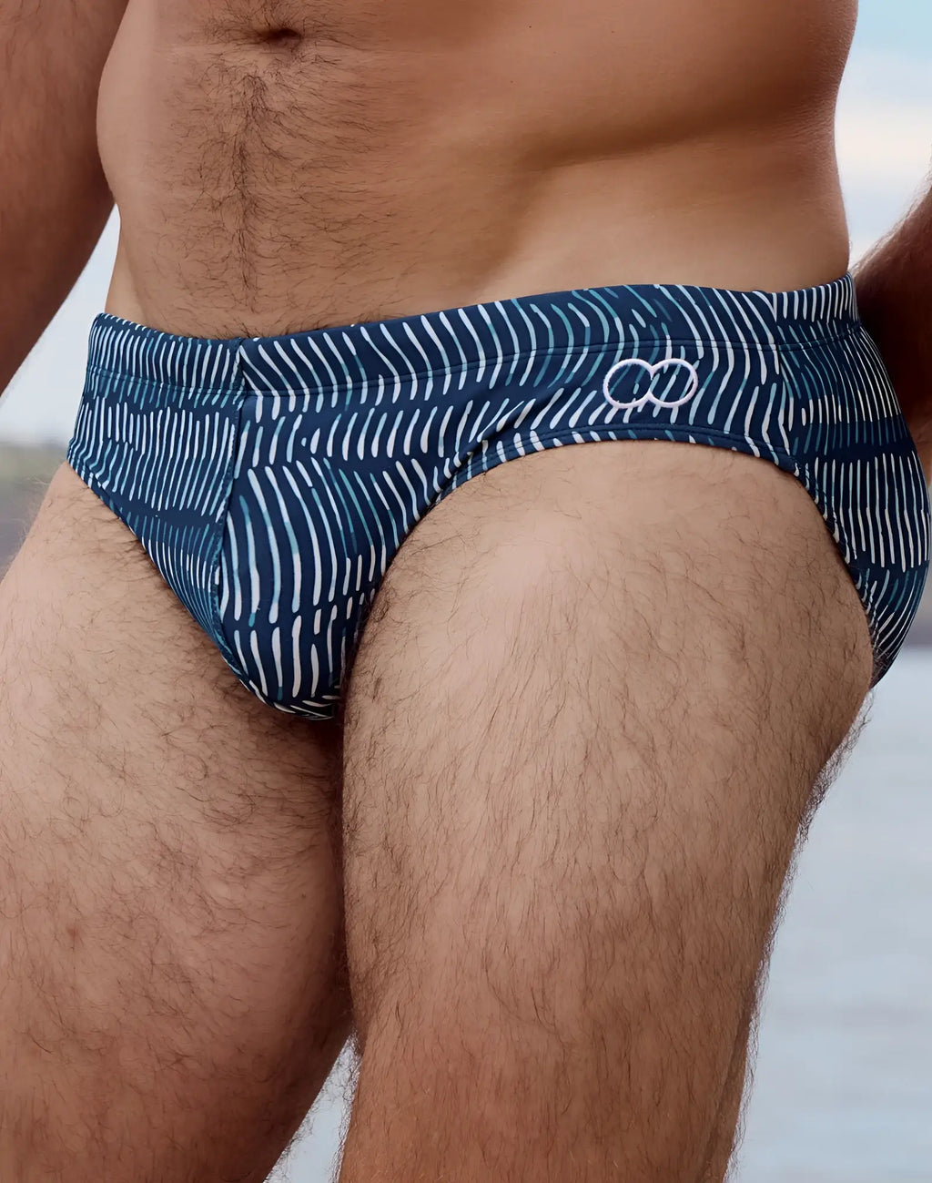 Blue 2EROS V10 print swim brief in Naiad Navy with white diagonal stripes and circular logo on waistband
