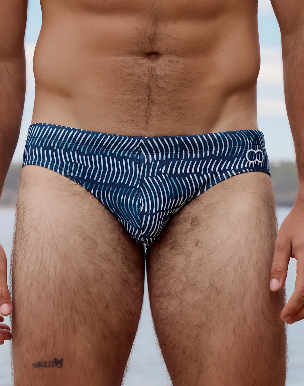 Blue 2eros v10 print swim brief with white wavy line pattern and small logo on waistband in naiad navy color
