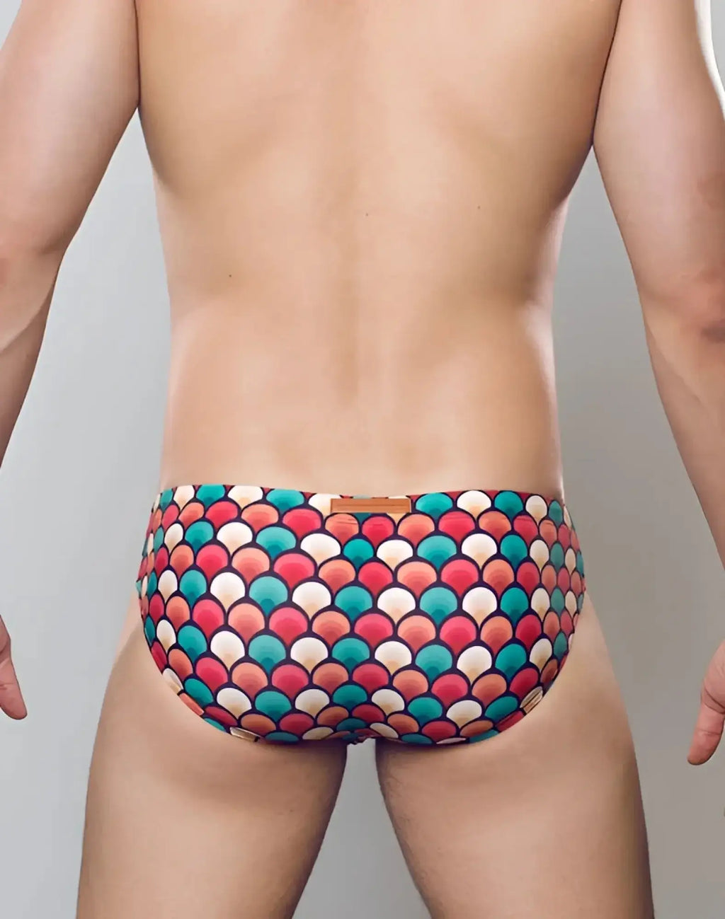 2eros v10 print swim brief in retro red featuring vibrant multicolored fish-scale pattern swim trunks