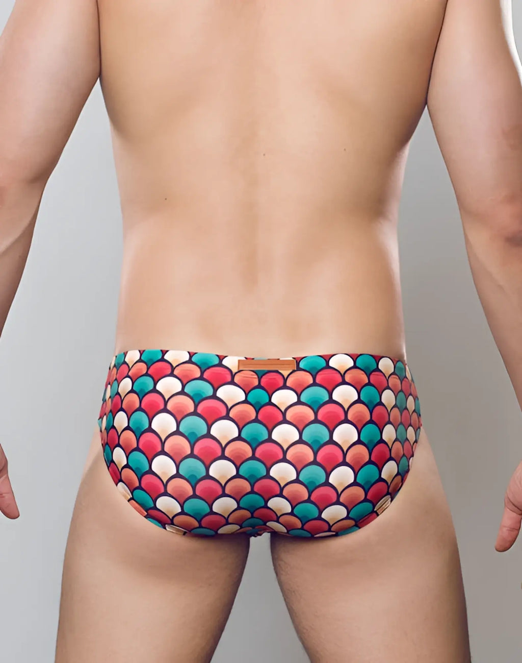 2eros v10 print swim brief in retro red featuring vibrant multicolored fish-scale pattern swim trunks