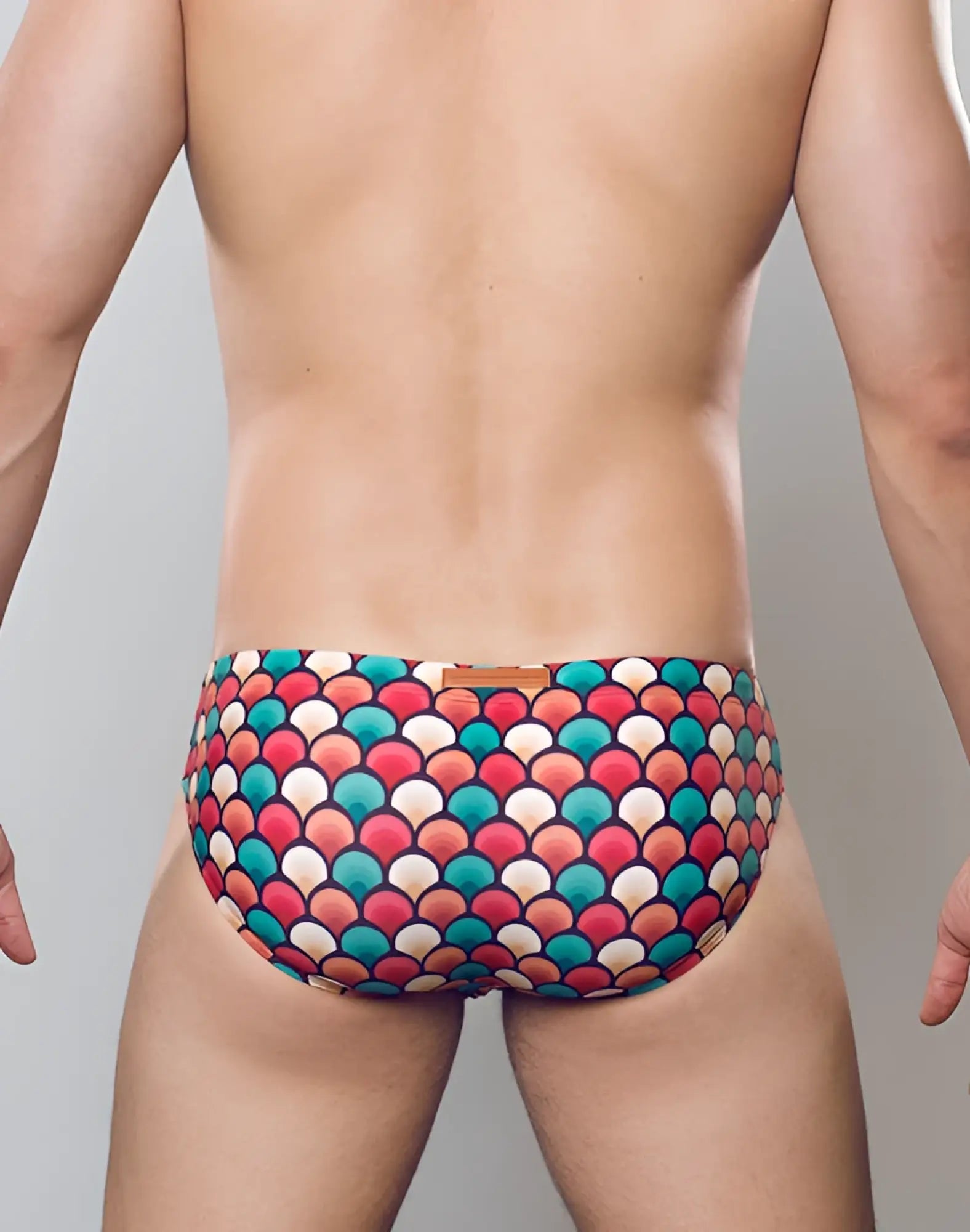 2eros v10 print swim brief in retro red featuring vibrant multicolored fish-scale pattern swim trunks