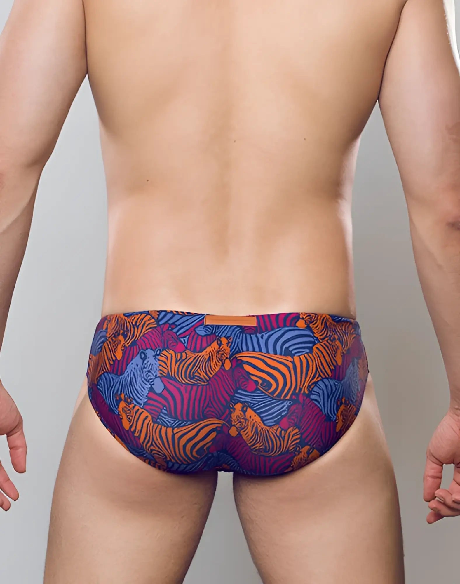 Vibrant 2EROS V10 print swim brief with bold orange and blue tiger designs on deep purple fabric stallion navy