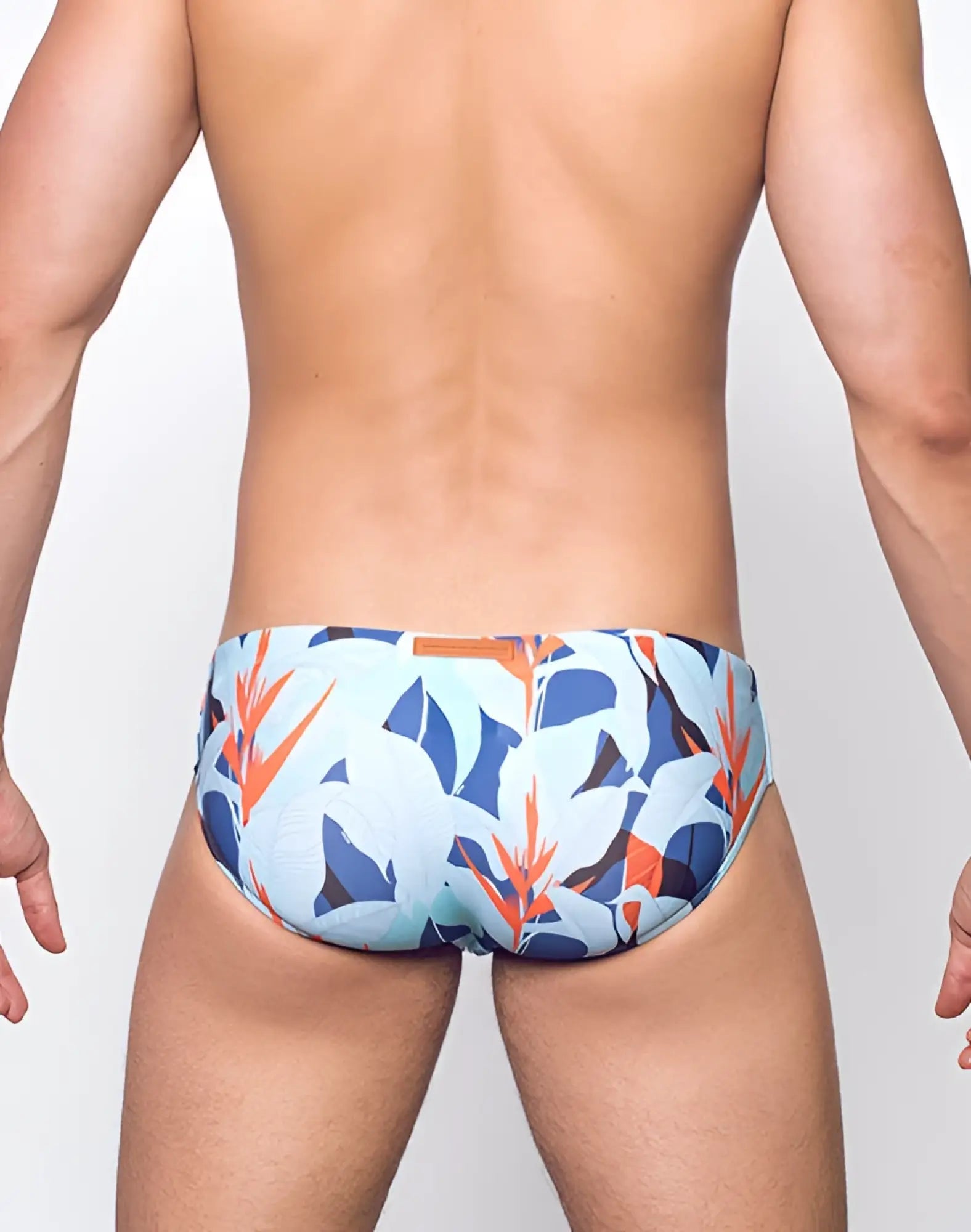 Light blue 2EROS V10 Print swim trunks with vibrant tropical leaf and flower pattern in orange navy and white
