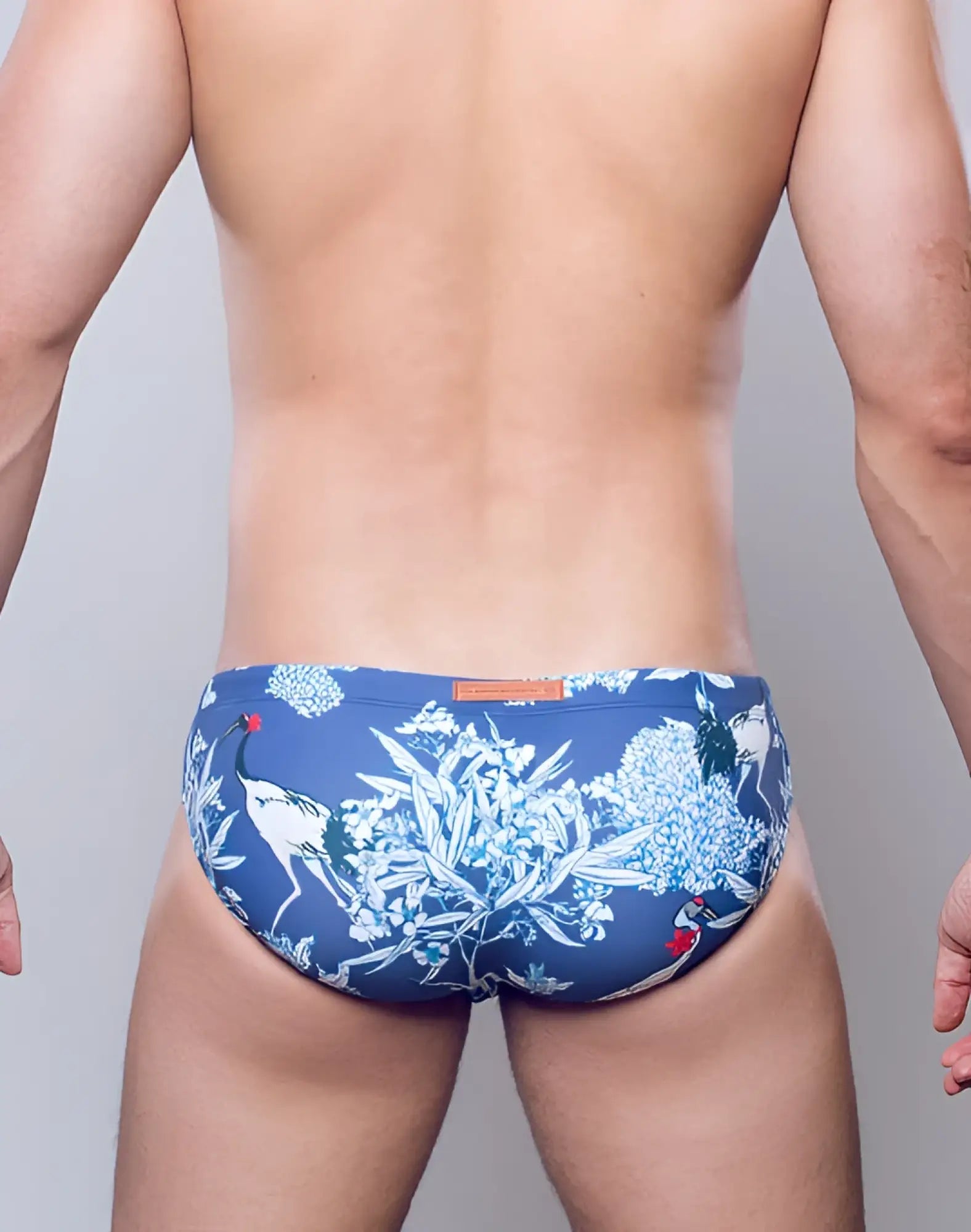 Blue swim trunks by 2EROS V10 print swim featuring white and red crane floral pattern for beachwear