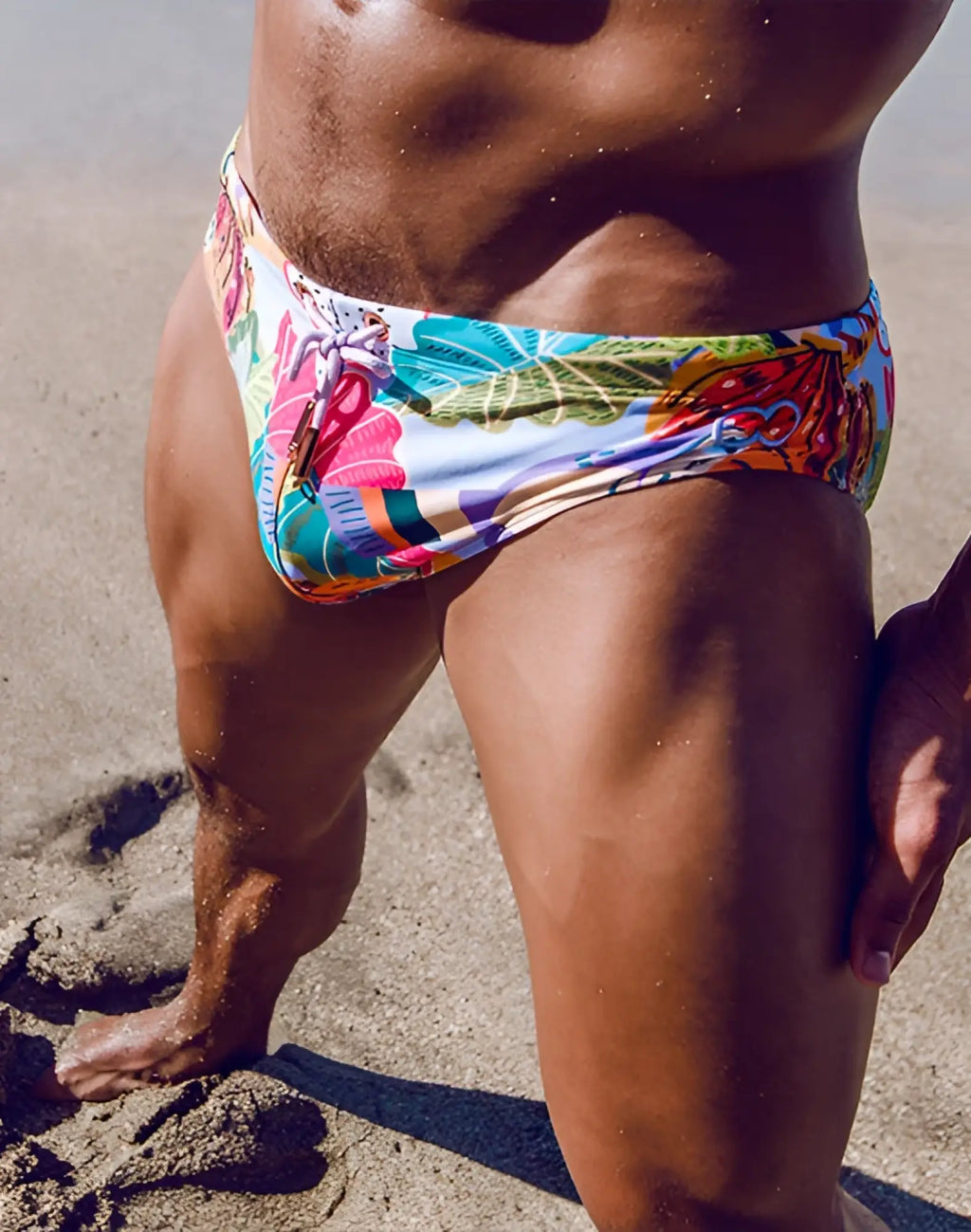 2EROS V10 Print swimwear featuring vibrant tropical print swim trunks with bold leaf and floral patterns on white