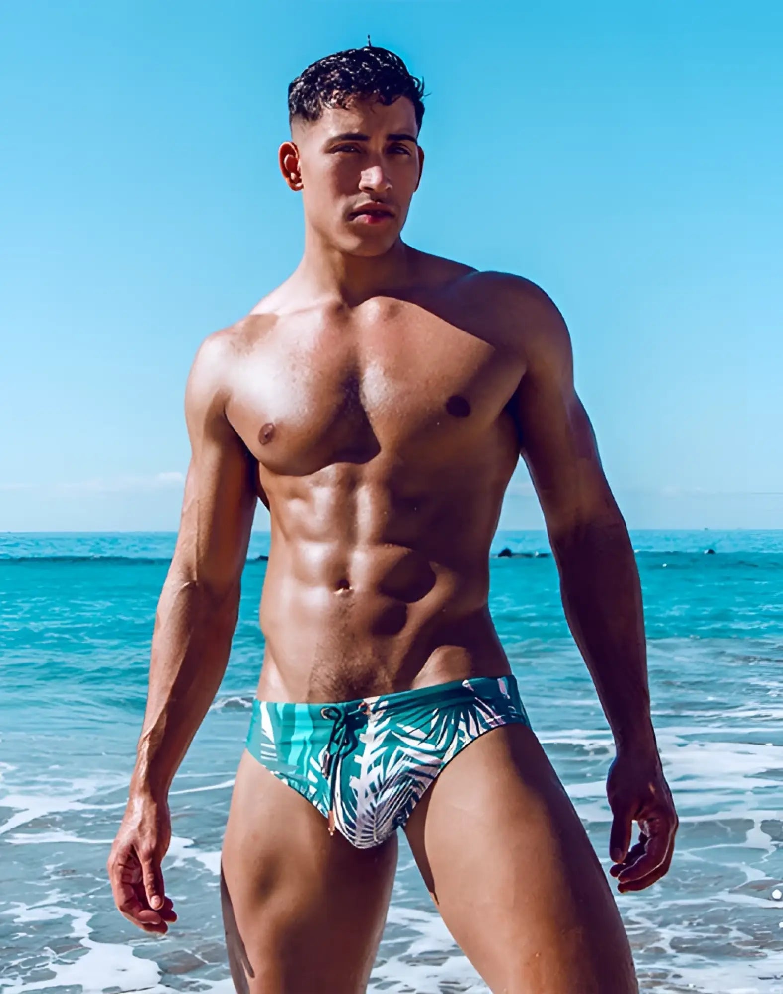 Teal and white tropical leaf patterned swim trunks by 2EROS V10 Print swimwear in lightweight quick-dry fabric