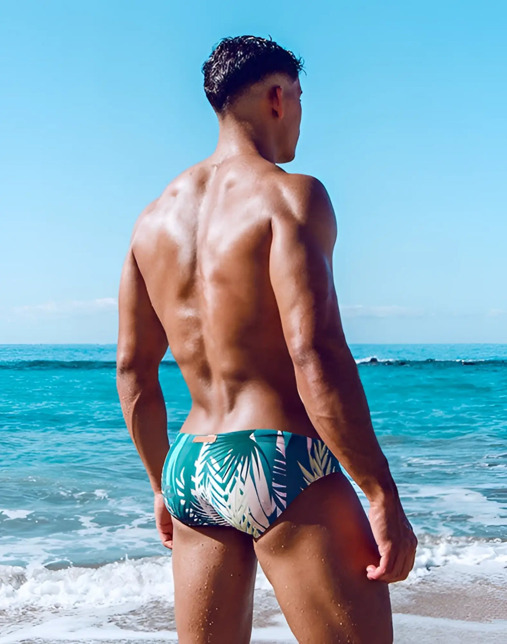 Green and white tropical leaf-patterned 2EROS V10 print swim trunks designed for swimwear use