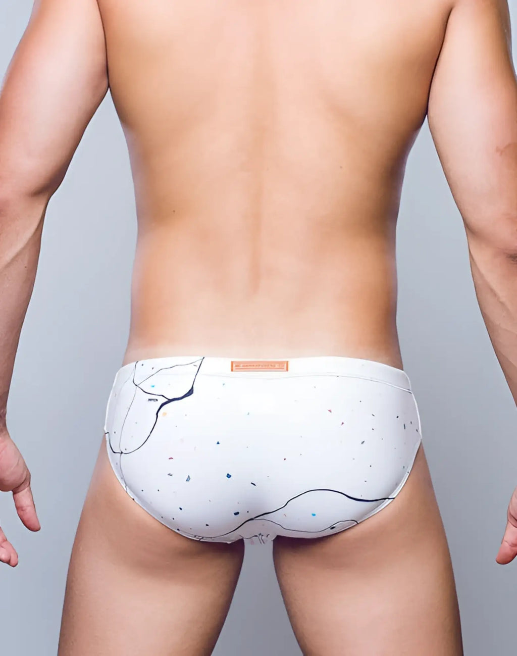 White briefs swimwear by 2EROS V10 with black abstract lines and blue speckles in marble print design