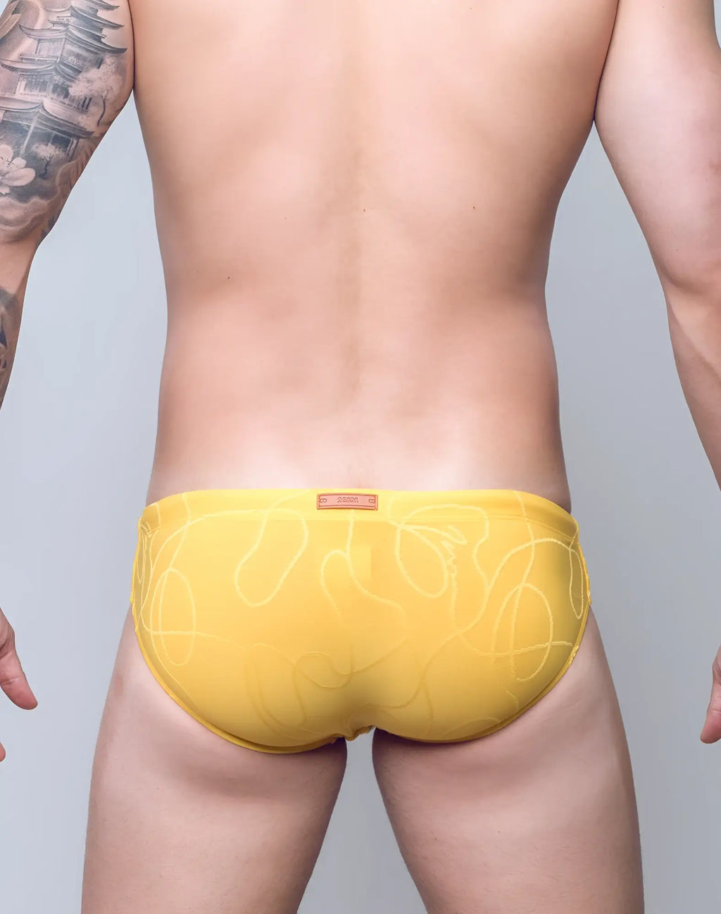 Bright yellow 2eros v10 textured swim brief with subtle white abstract line pattern ideal for swimming and beachwear