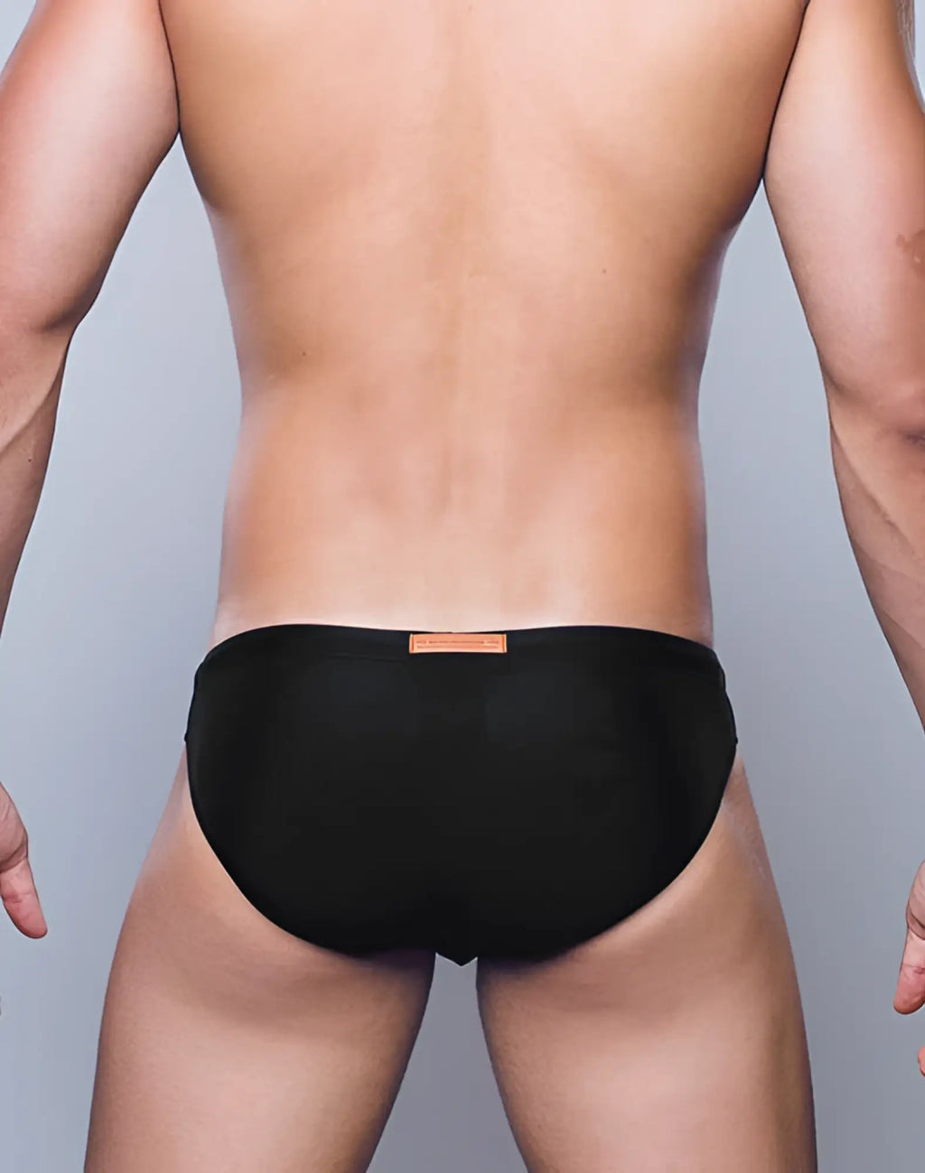 Black briefs swimwear by 2EROS featuring a small tan tag at the waistband in core black color