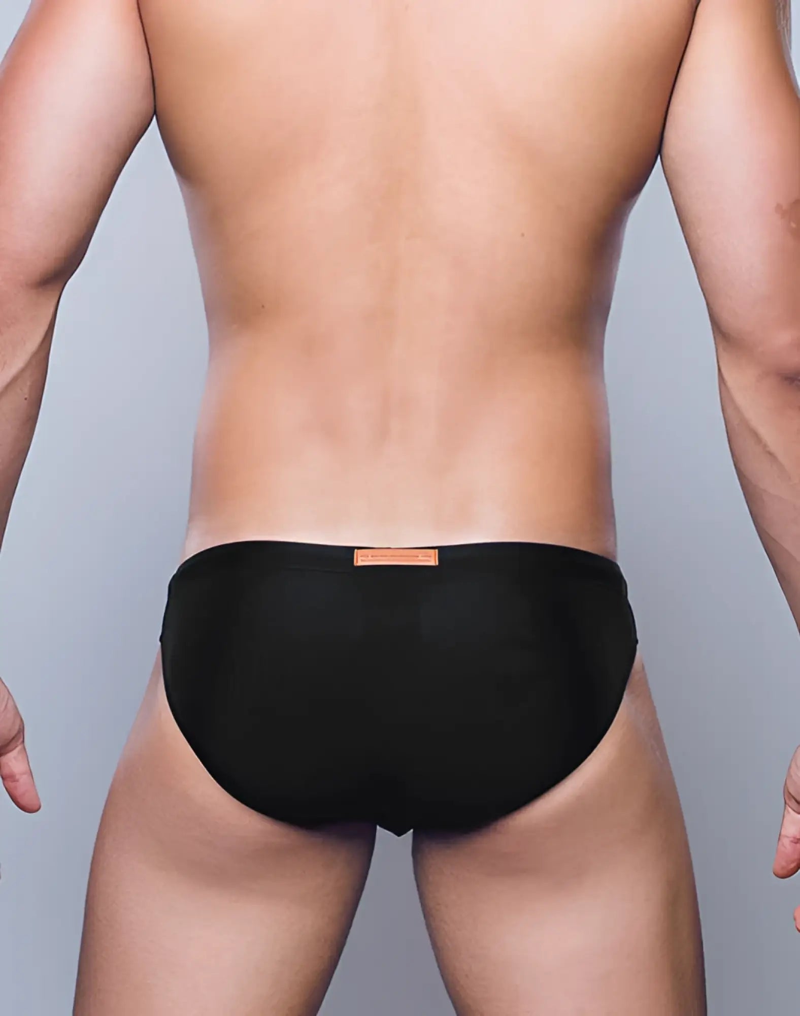 Black briefs swimwear by 2EROS featuring a small tan tag at the waistband in core black color