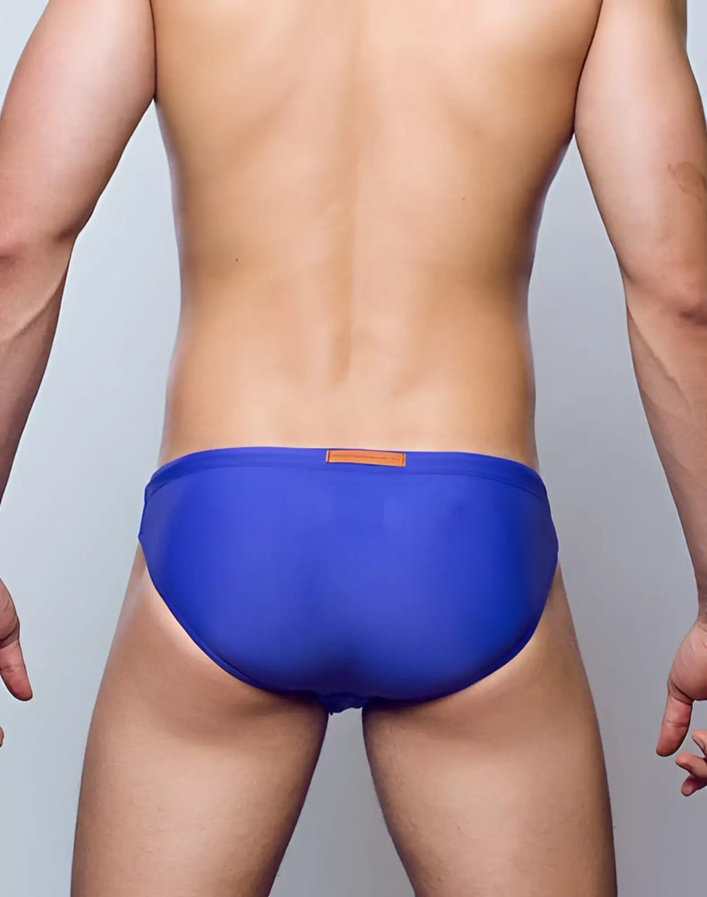 2eros v20 core swimwear blue swim trunks with small orange rectangular tag at waistband front view