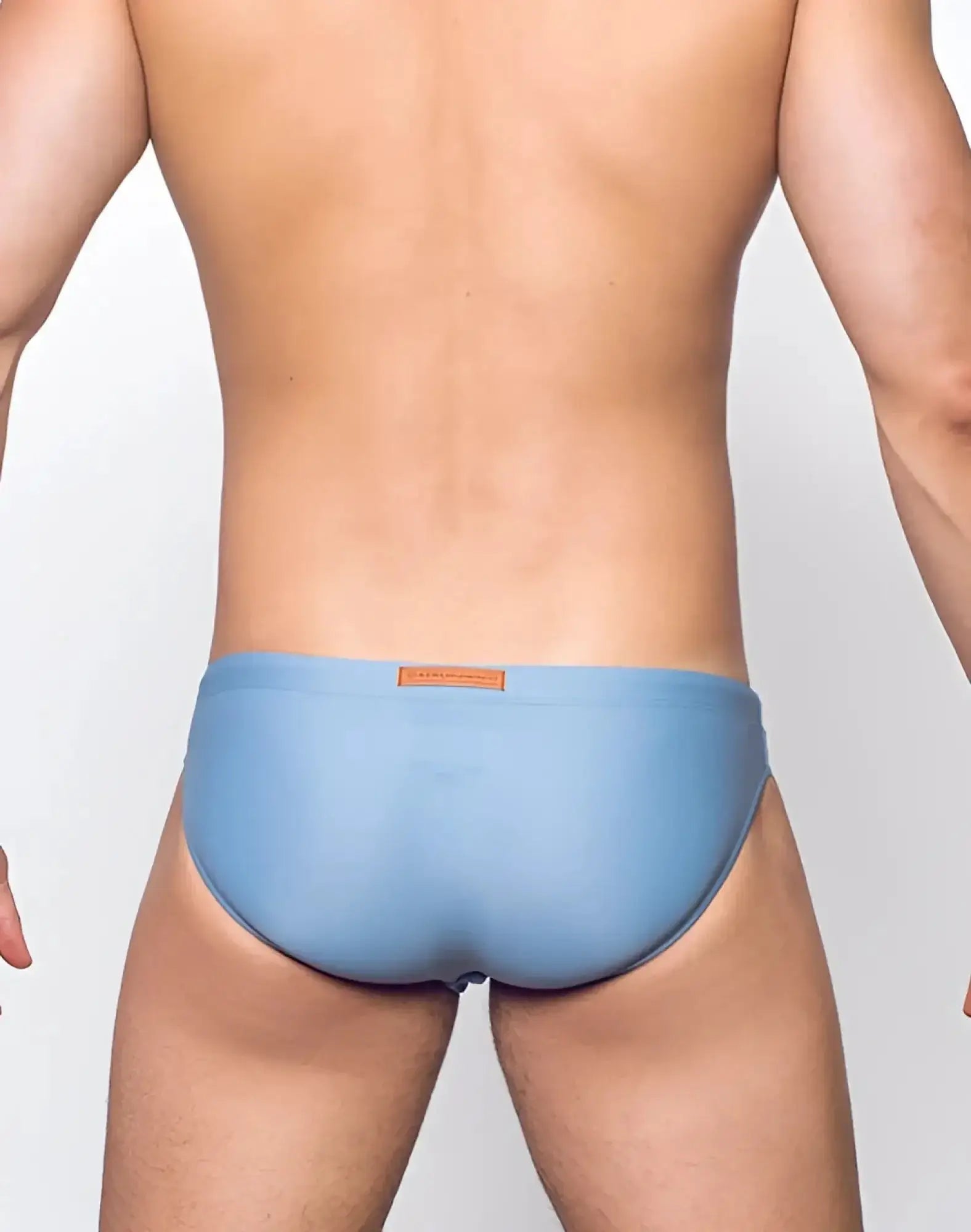 Light blue smooth-textured 2eros v20 core swim trunks with small brown label at waistband in faded denim style