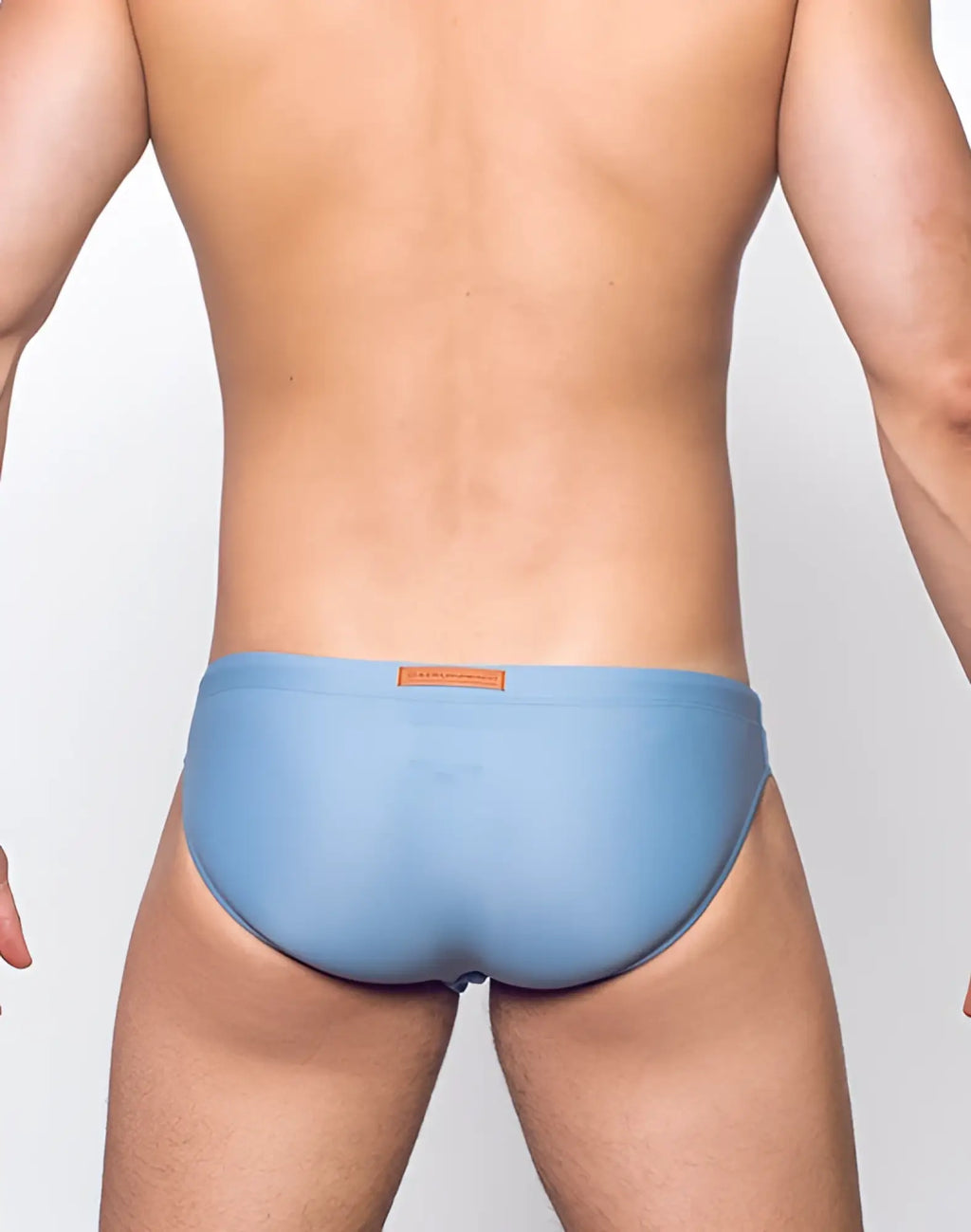 Light blue smooth-textured 2eros v20 core swim trunks with small brown label at waistband in faded denim style
