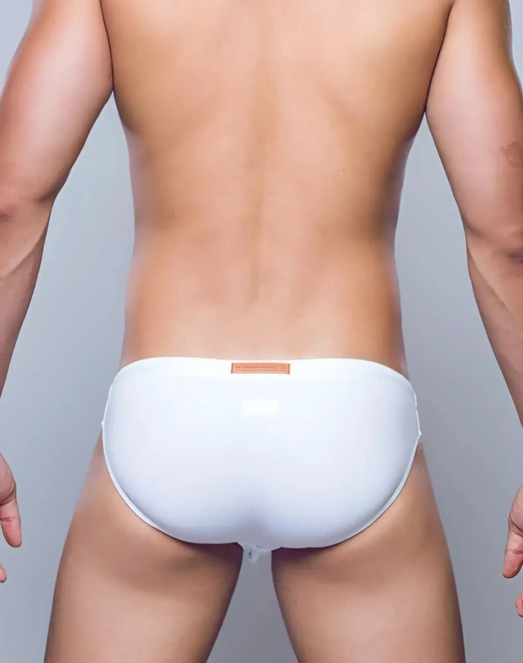 White glossy 2EROS V20 Core swimwear trunks with a small orange label at the waistband for swimming use