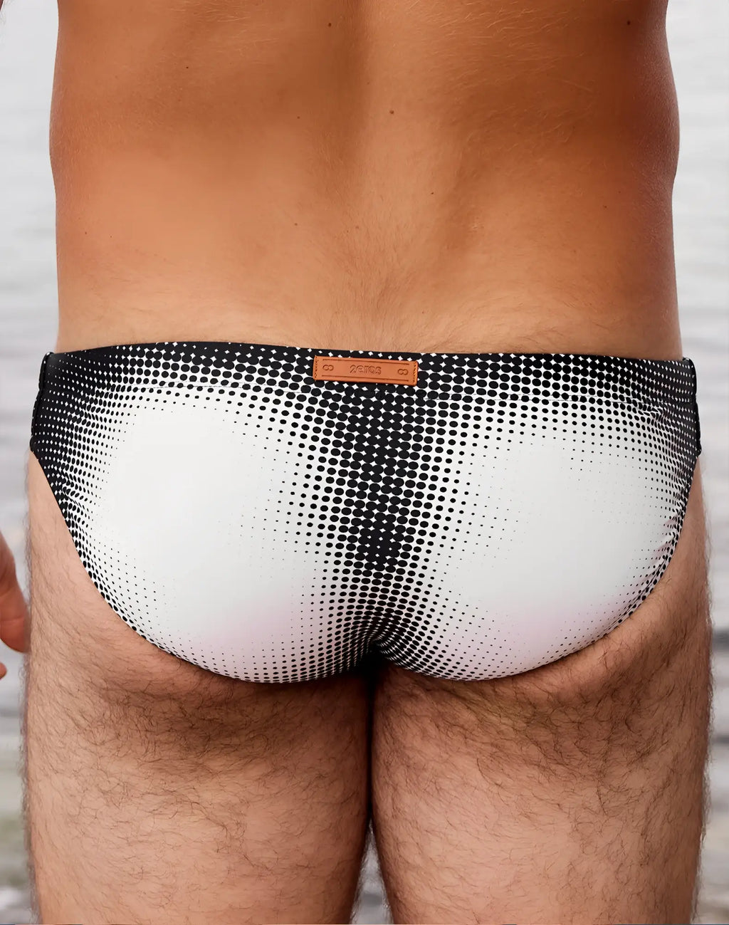 2eros v20 printed swim brief in black and white halftone pattern with brown leather-like brand tag for swimming
